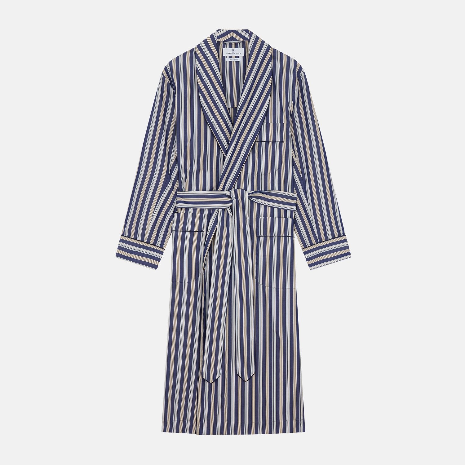 View 1 of product The Turnbull & Asser Blue Multi Stripe Cotton Gown features blue and white vertical stripes, long sleeves, a shawl collar, front pockets, and a matching waist tie, shown on a plain white background.