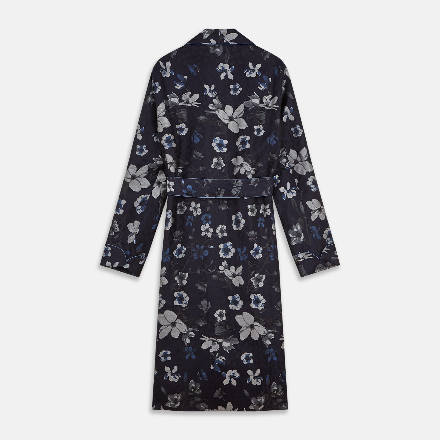 View 5 of product The Navy Floral Silk Jacquard Pierce Gown by Turnbull & Asser features a shawl collar, long sleeves, matching fabric belt, and elegant grey and blue floral design.
