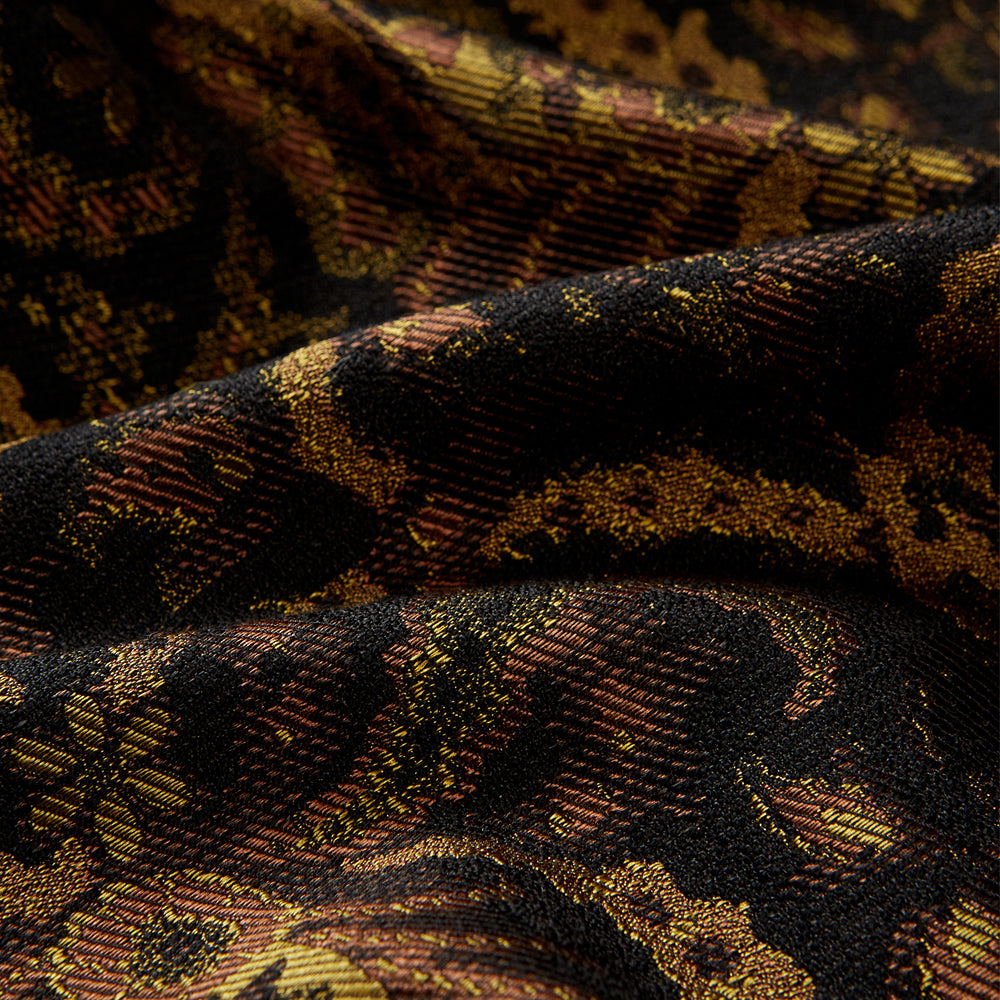 The Turnbull & Asser Gold Multi Floral Cotton, Wool & Silk Jacquard Pierce Gown features a shawl collar, matching belt, golden lining, and an elegant floral pattern in luxurious black, gold, and brown tones.