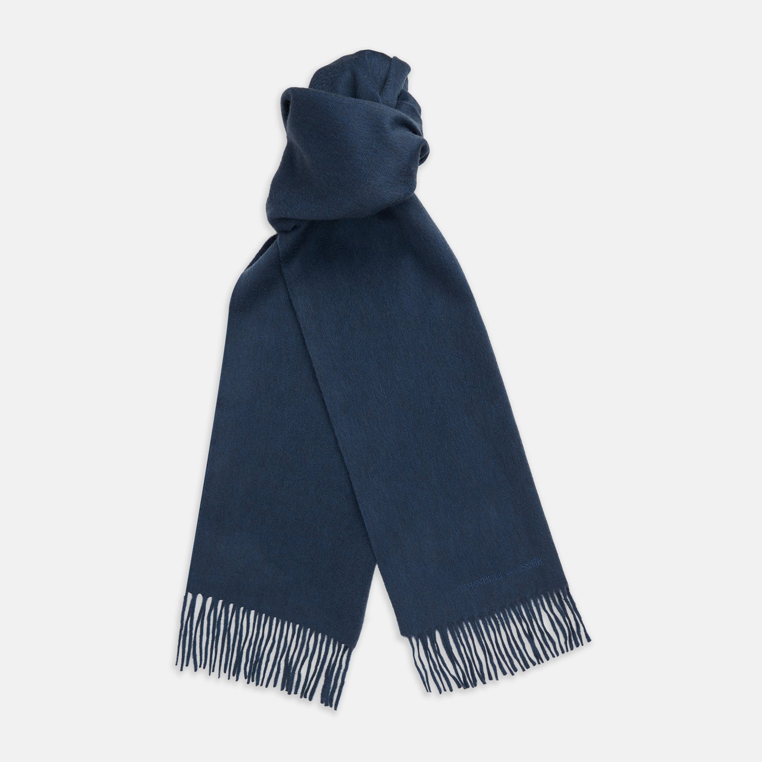 View 1 of product The Turnbull & Asser Slate Blue Purled Fringe Cashmere Scarf, neatly folded on a white background, is a stylish winter accessory.