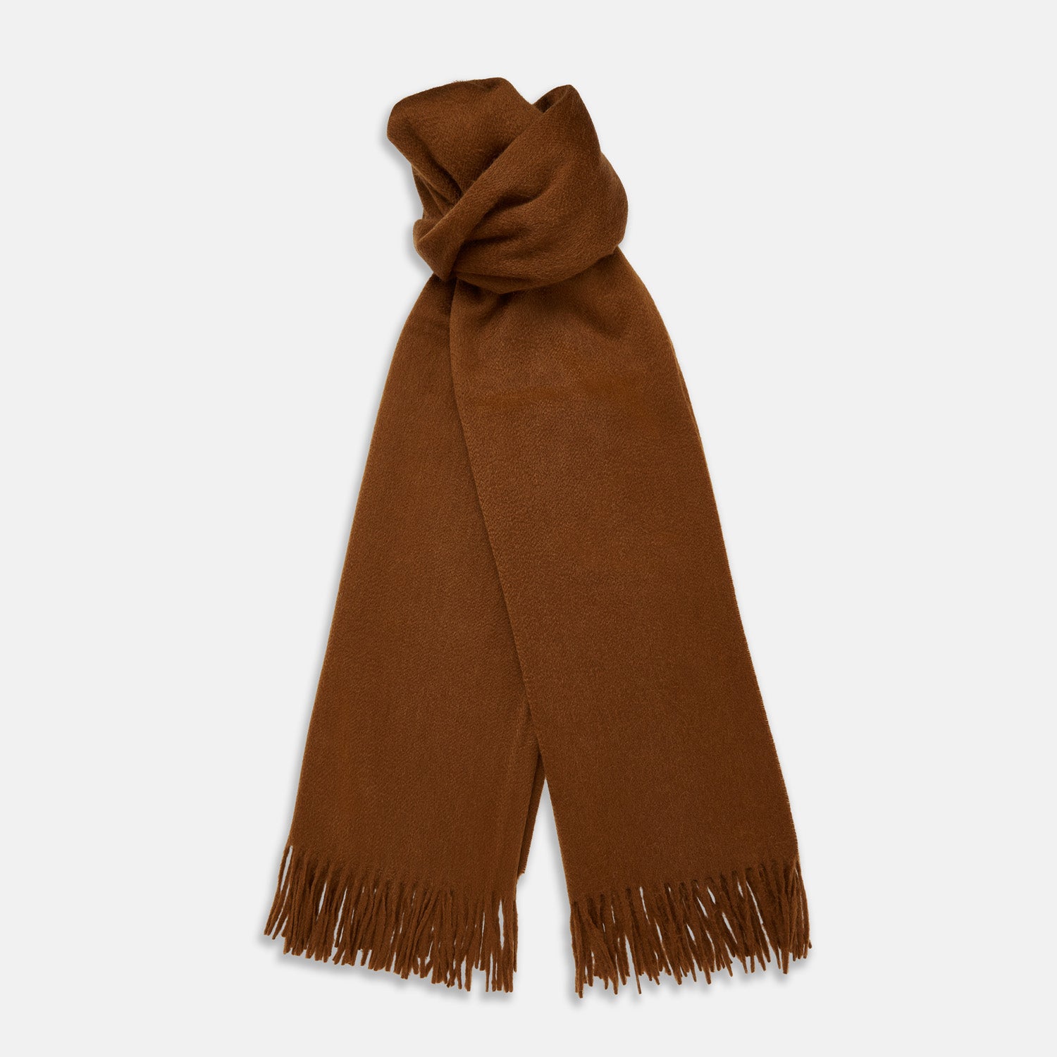 View 1 of product The Turnbull & Asser Rust Cashmere Wilde Stole Scarf is oversized with a soft texture, features short fringe detailing on the ends, and is shown loosely tied against a plain white background.