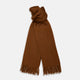 The Turnbull & Asser Rust Cashmere Wilde Stole Scarf is oversized with a soft texture, features short fringe detailing on the ends, and is shown loosely tied against a plain white background.