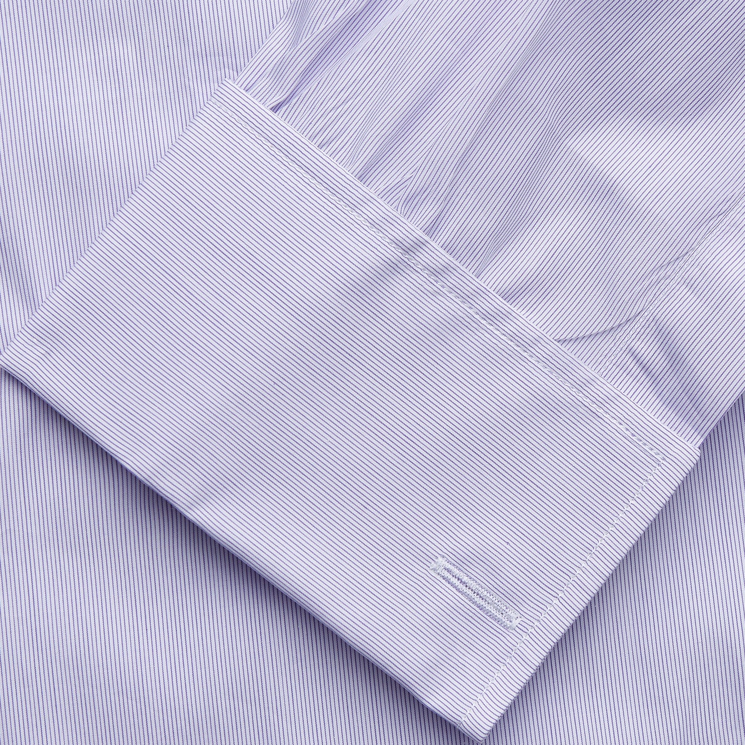 View 3 of product The Turnbull & Asser Purple Hairline Stripe Regular Fit Twill Shirt features a T&A collar, double cuffs, long sleeves, and white buttons, shown laid flat on a white background.