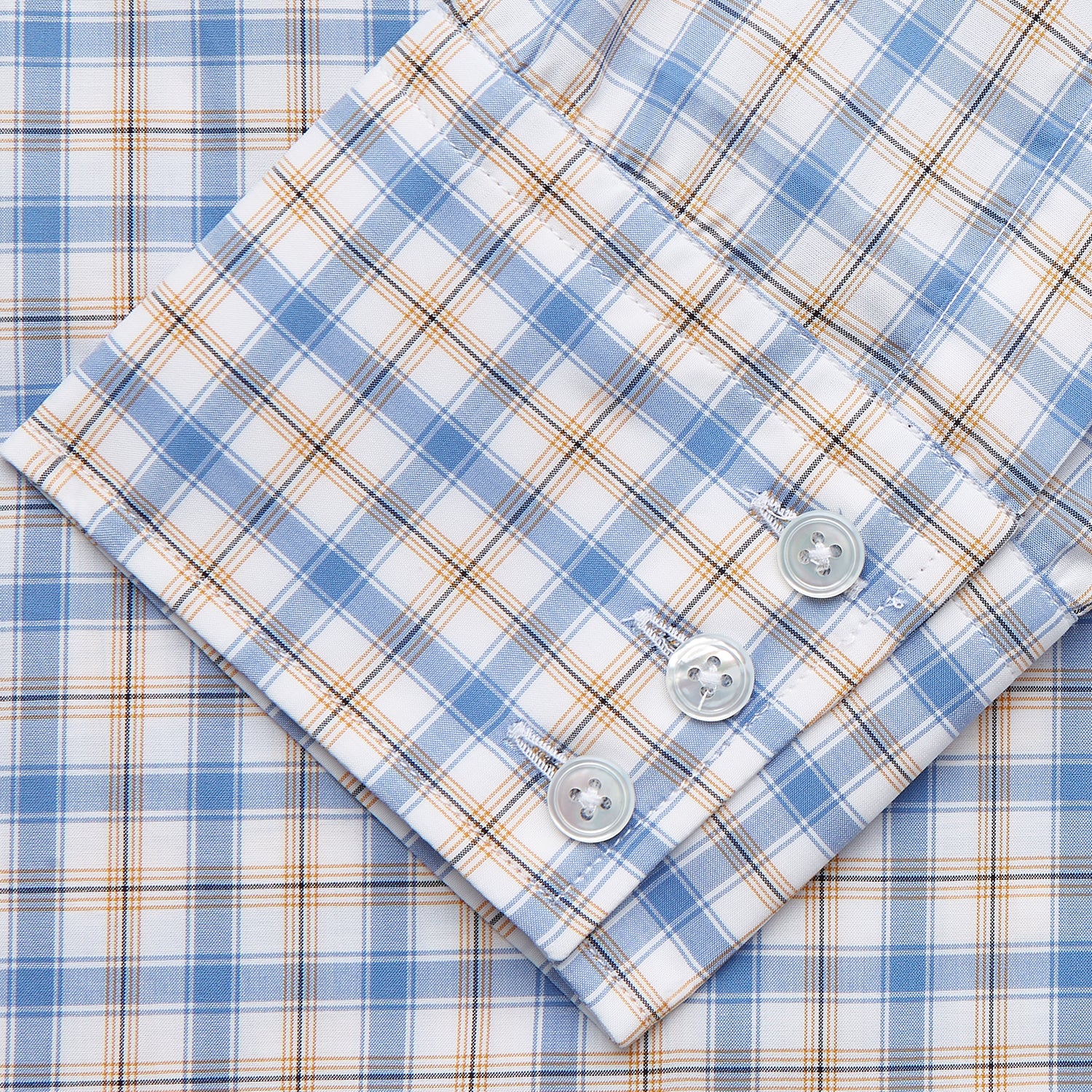 View 3 of product The Turnbull & Asser Blue Multi Check Regular Fit Shirt features a T&A collar, 3 button cuffs, a blue, tan, and white check pattern, and is crafted from Italian cotton poplin. It is shown laid flat on a white background.
