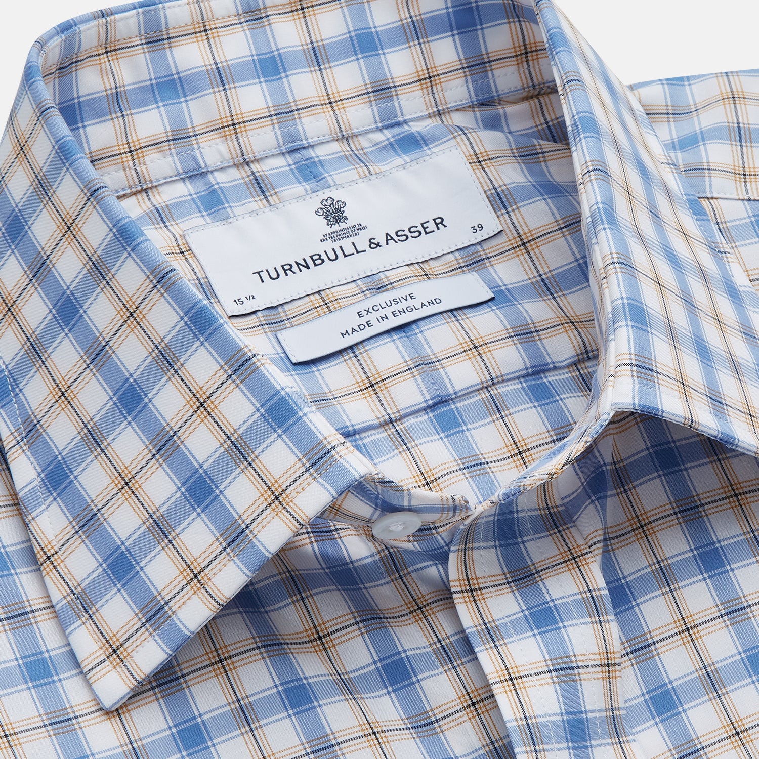 View 2 of product The Turnbull & Asser Blue Multi Check Regular Fit Shirt features a T&A collar, 3 button cuffs, a blue, tan, and white check pattern, and is crafted from Italian cotton poplin. It is shown laid flat on a white background.