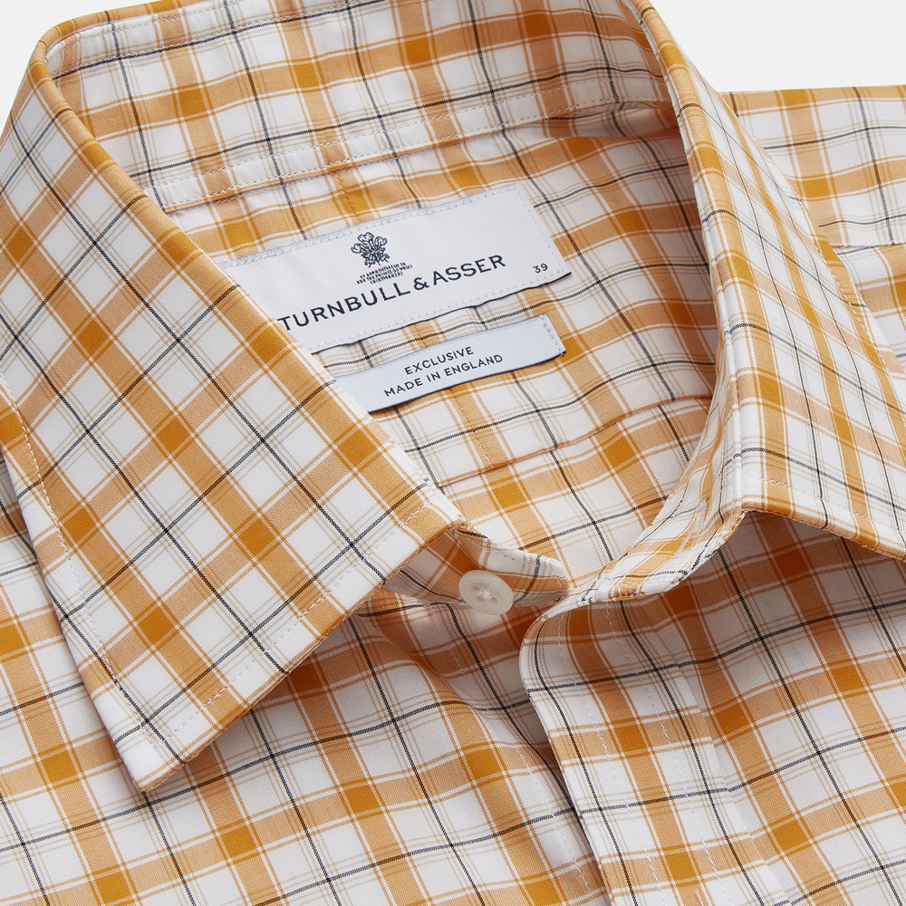 The Orange Multi Check Regular Fit Shirt by Turnbull & Asser features a T&A collar, 3 button cuffs, and a classic button-up design in Italian cotton, displayed on a plain white background.