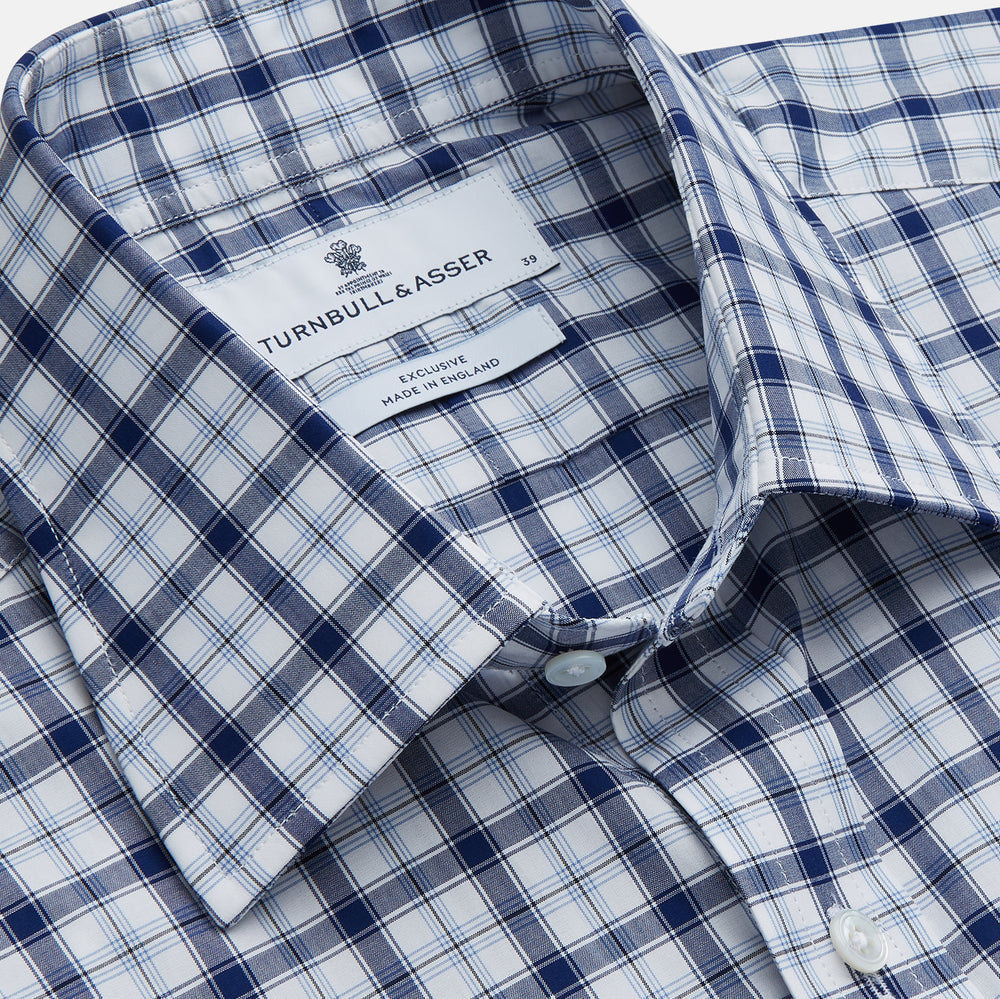 Turnbull & Asser's Navy Multi Check Regular Fit Shirt features a T&A collar, 3 button cuffs, and a blue and white plaid pattern, crafted from Italian cotton poplin with long sleeves and shown on a plain white background.