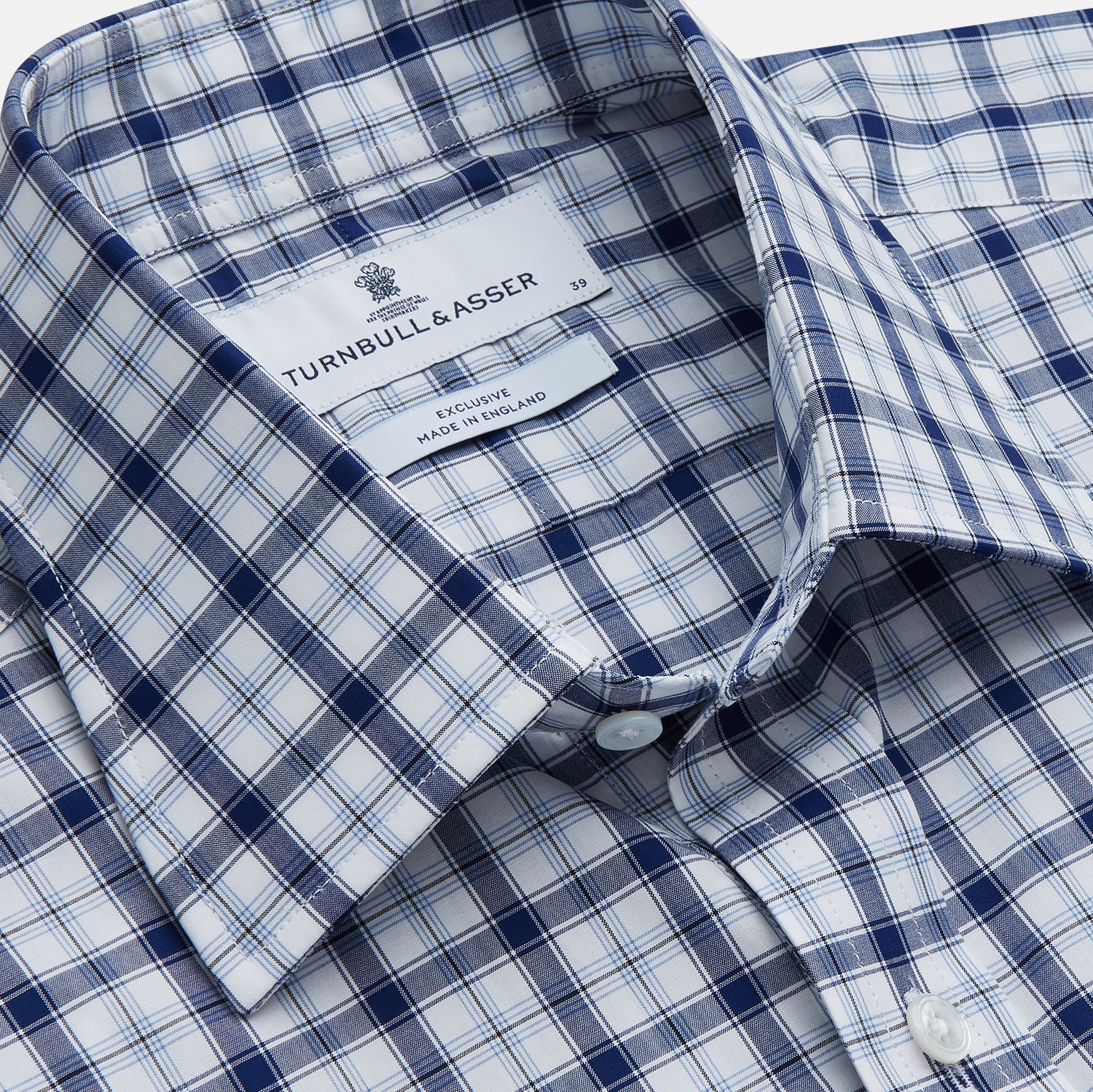 View 2 of product Turnbull & Asser's Navy Multi Check Regular Fit Shirt features a T&A collar, 3 button cuffs, and a blue and white plaid pattern, crafted from Italian cotton poplin with long sleeves and shown on a plain white background.