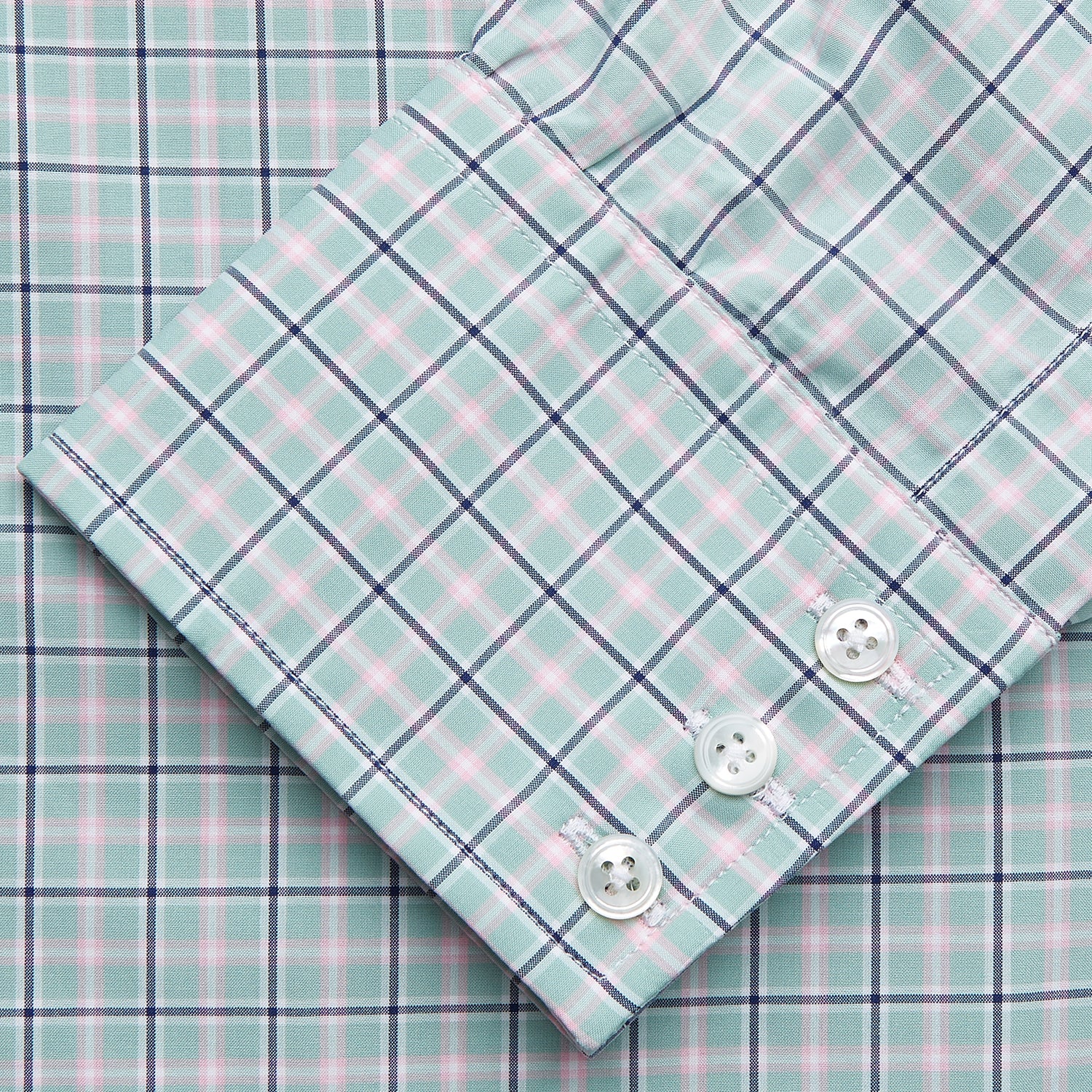 View 3 of product The Turnbull & Asser Green, Navy & Pink Check Regular Fit Shirt features a T&A collar, 3 button cuffs, and white buttons. Crafted from Italian cotton poplin, it’s displayed on a white background.