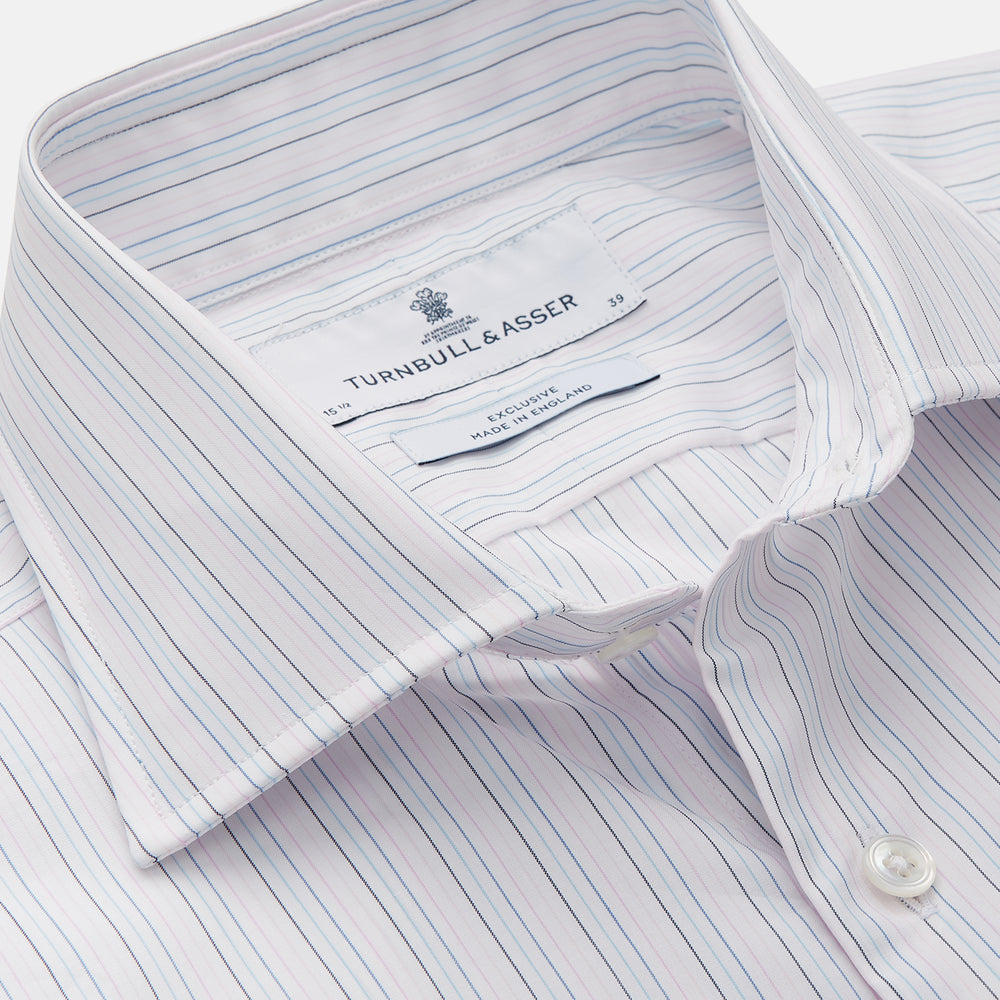 The Turnbull & Asser Blue Multi Stripe Tailored Fit Shelton Shirt features a Kent collar and thin blue and gray vertical stripes on white. This long-sleeve, button-down is displayed neatly against a plain white background.