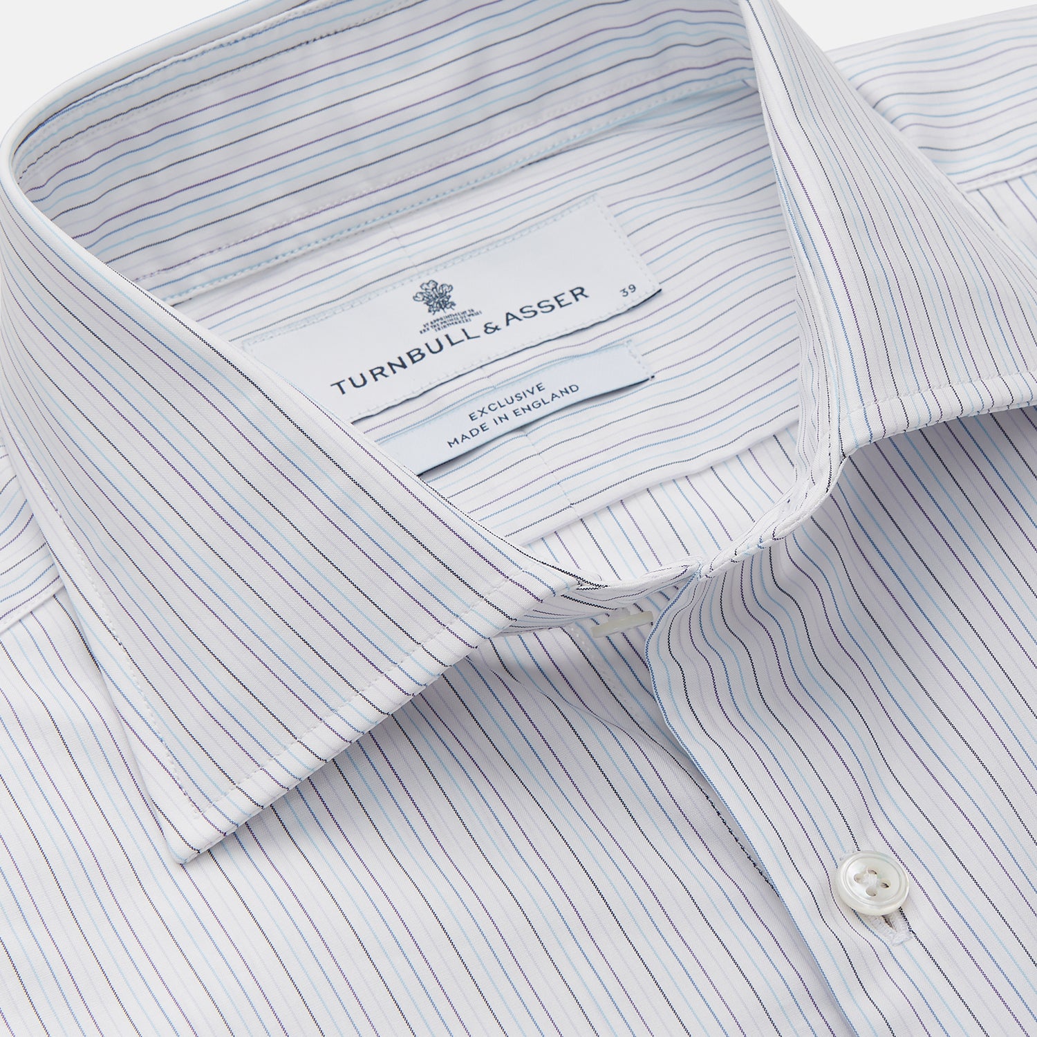 View 2 of product The Turnbull & Asser Purple Multi Stripe Tailored Fit Shelton Shirt features a Kent collar and buttoned cuffs, with a vertical pinstripe pattern, displayed flat on a white surface.