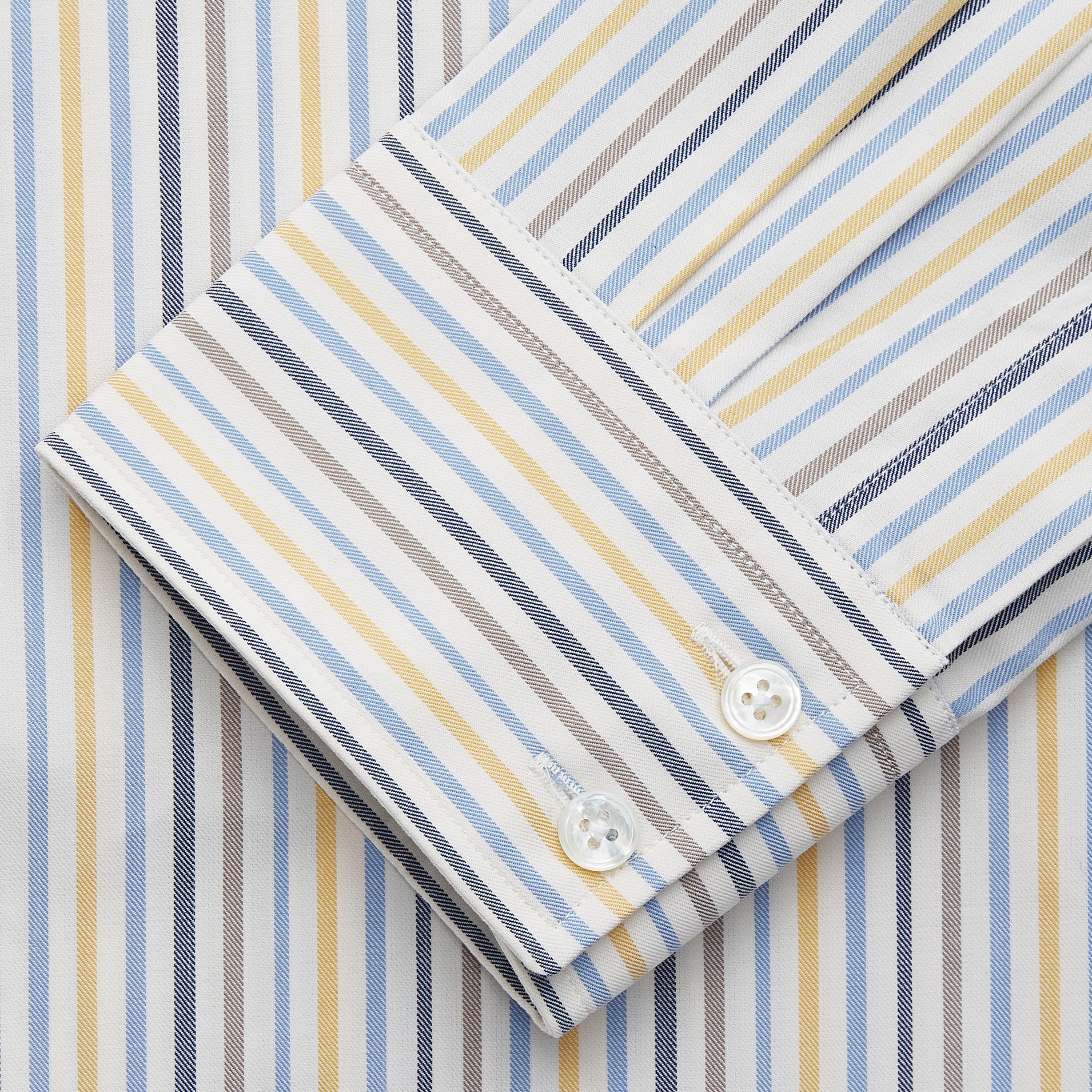 View 3 of product Turnbull & Asser’s Yellow Multi Stripe Tailored Fit Shirt features a Kent collar, blue, yellow, and white stripes on a light background, 2-button cuffs, and a curved hem for a refined look.