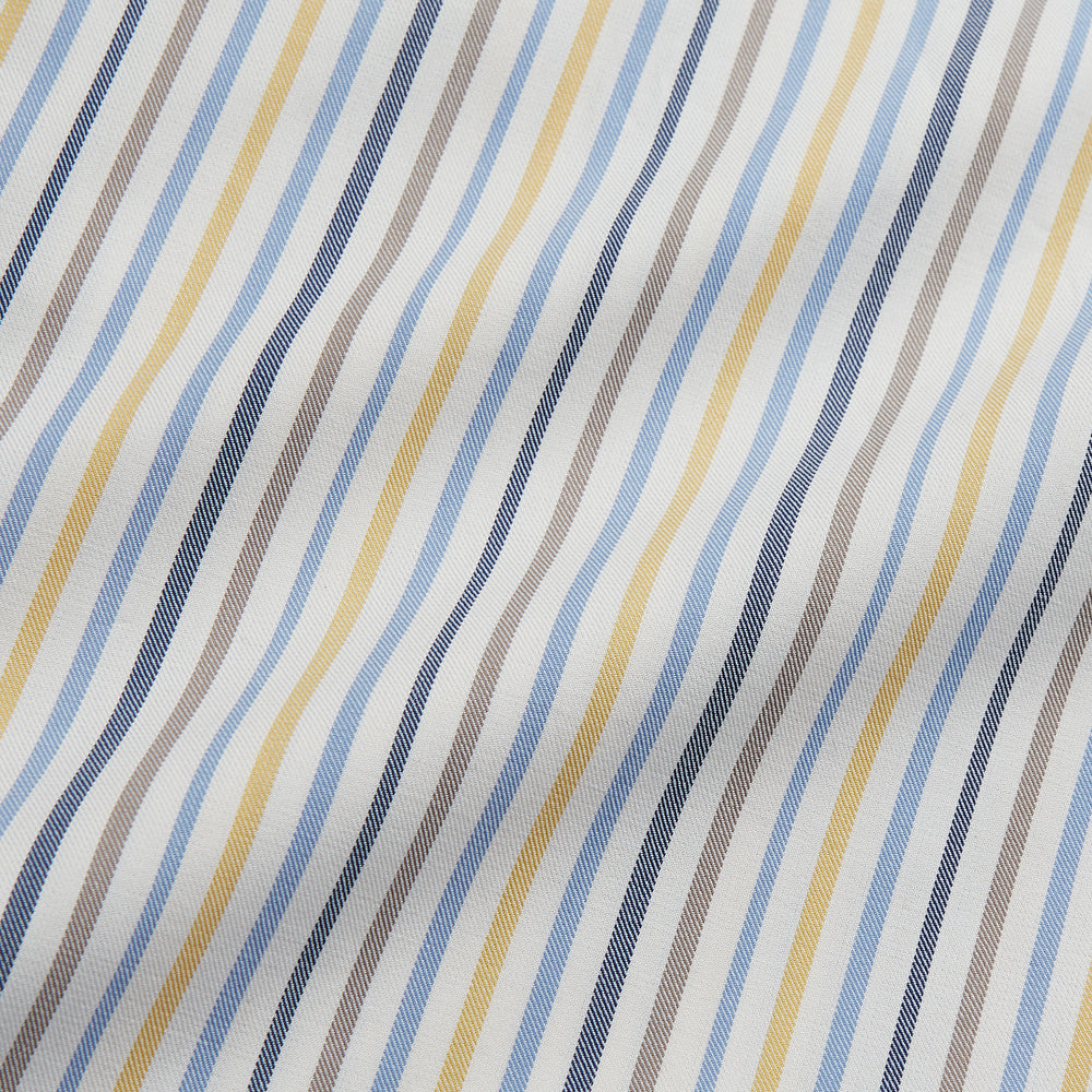 Turnbull & Asser’s Yellow Multi Stripe Tailored Fit Shirt features a Kent collar, blue, yellow, and white stripes on a light background, 2-button cuffs, and a curved hem for a refined look.