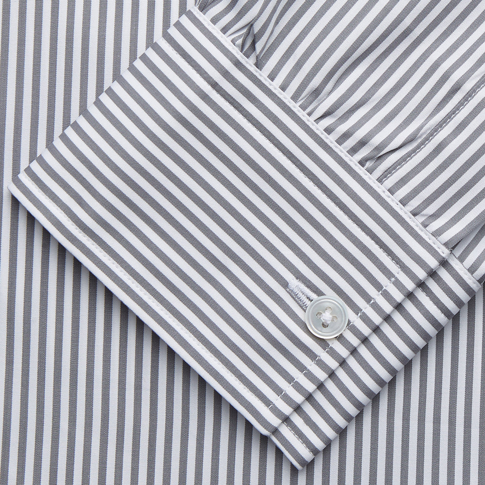 The Turnbull & Asser Grey & White Stripe Weekend Fit Shirt features a Derby collar, 1-button cuffs, and chest pocket—ideal for casual weekends. Shown on a plain white background.