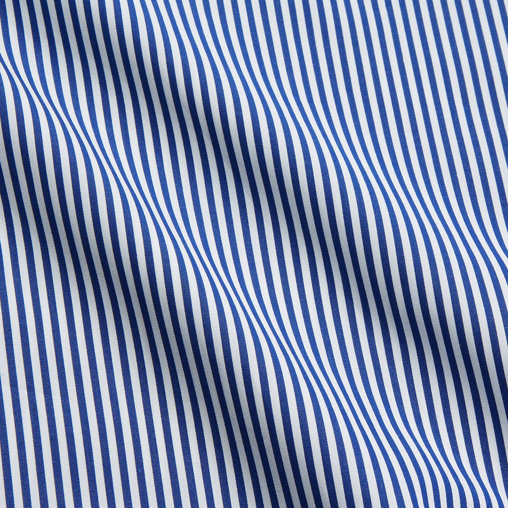 The Turnbull & Asser Navy & White Stripe Weekend Fit Shirt features a Derby collar, 1-button cuffs, front chest pocket, vertical stripes, and white buttons. Displayed flat on a white background.