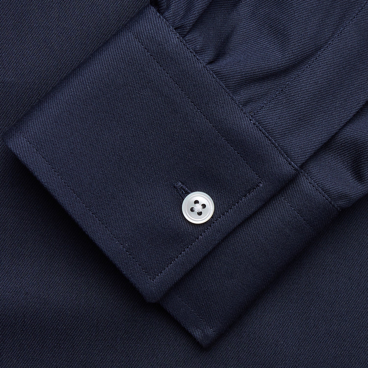View 3 of product The Turnbull & Asser Navy Weekend Fit Shirt features a Dorset collar, 1 button cuffs, and white buttons, shown laid flat against a white background.