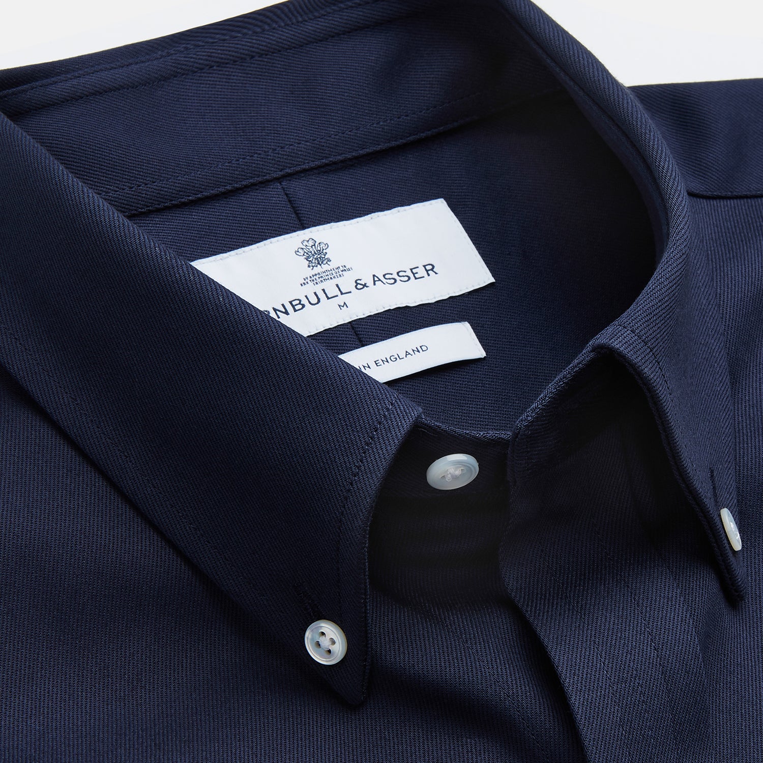 View 2 of product The Turnbull & Asser Navy Weekend Fit Shirt features a Dorset collar, 1 button cuffs, and white buttons, shown laid flat against a white background.