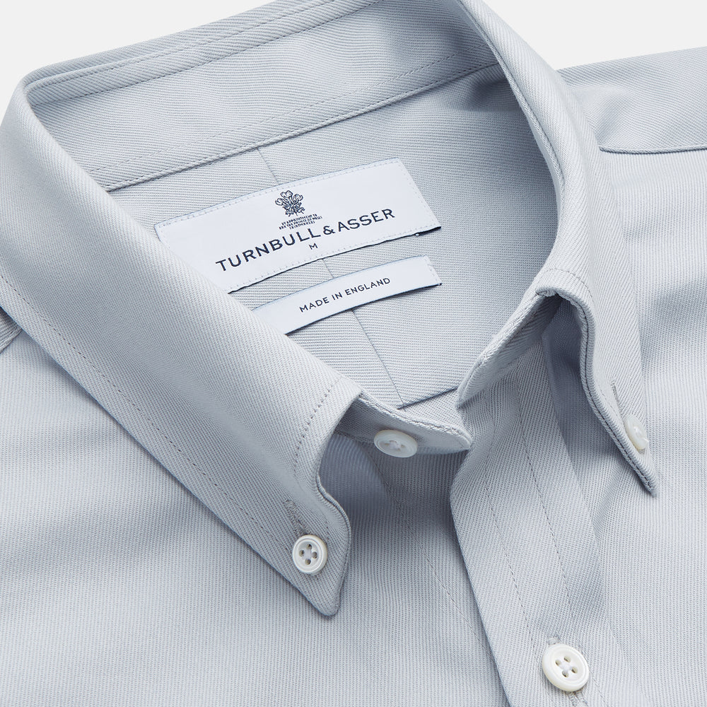 A grey Weekend Fit Shirt by Turnbull & Asser, featuring a Dorset collar and single button cuffs, is displayed against a plain white background.