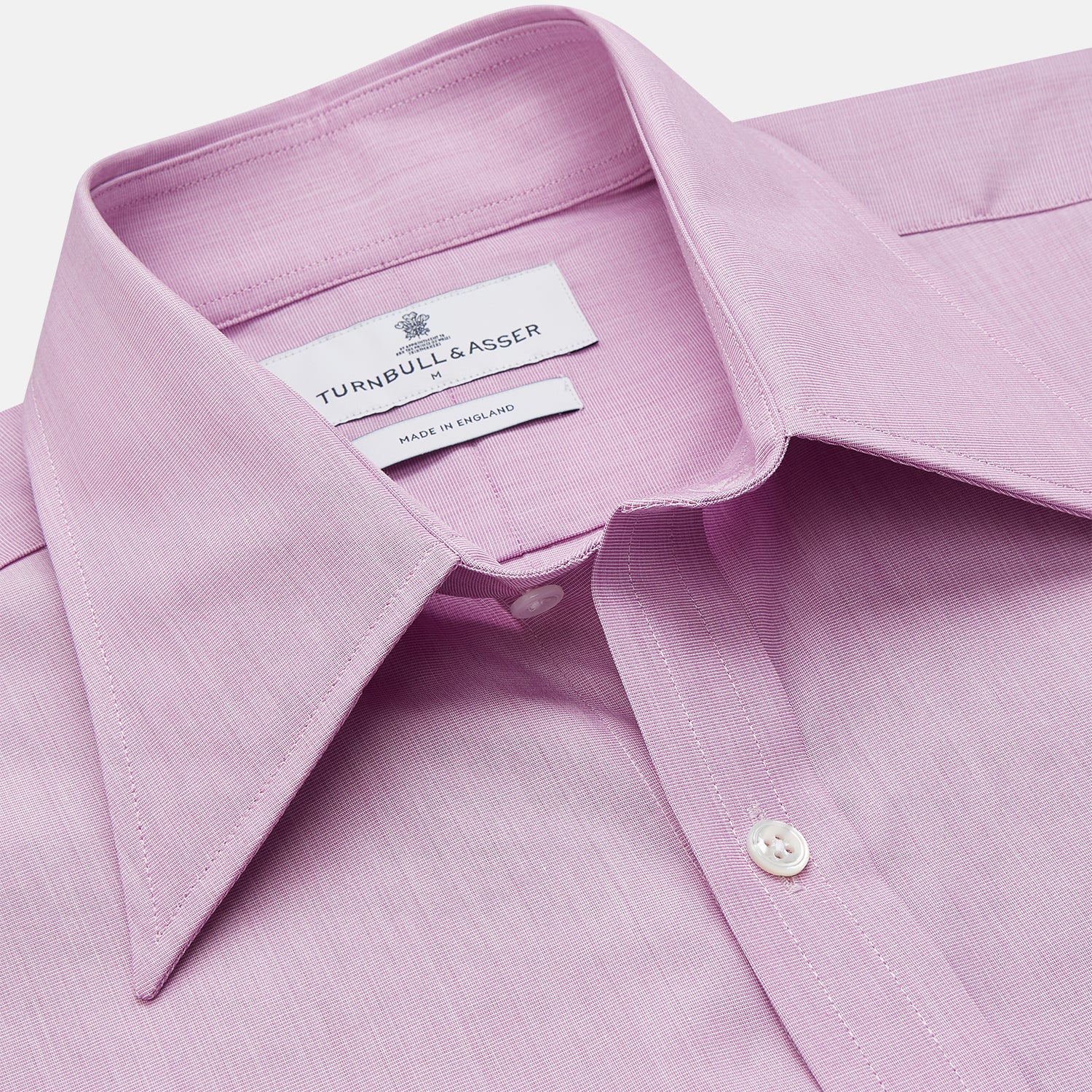 View 2 of product The Turnbull & Asser Pink Weekend Fit Shirt features a Long Point collar, single button cuffs, and a front pocket, shown laid flat on a white background.