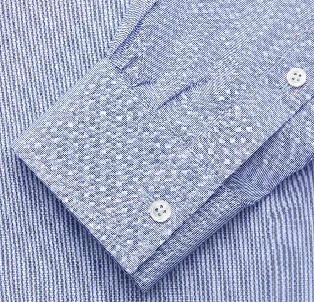 The Turnbull & Asser Pale Blue Weekend Fit Shirt with a Long Point collar and single button cuffs is laid flat on a white background.