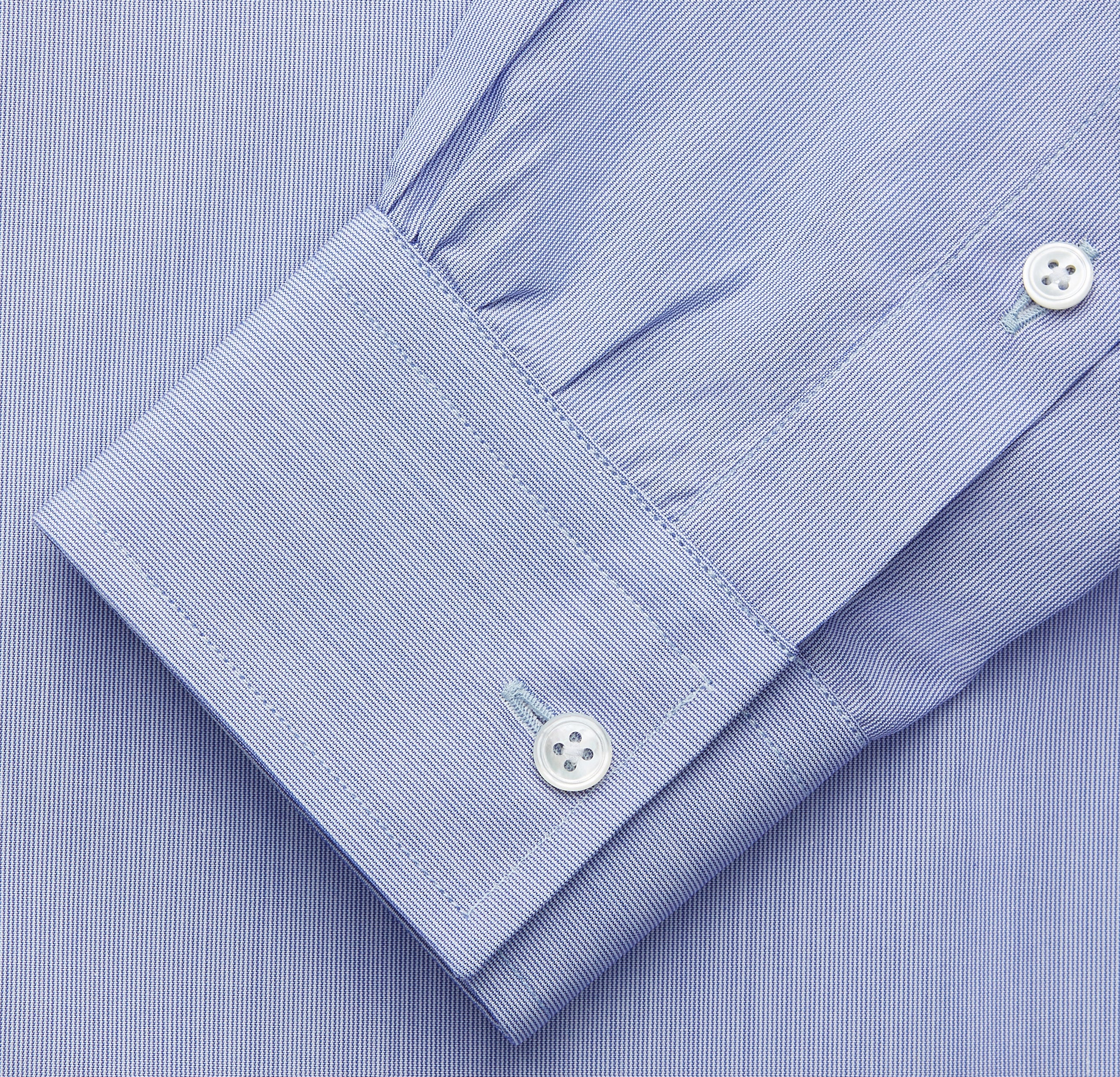 View 3 of product The Turnbull & Asser Pale Blue Weekend Fit Shirt with a Long Point collar and single button cuffs is laid flat on a white background.