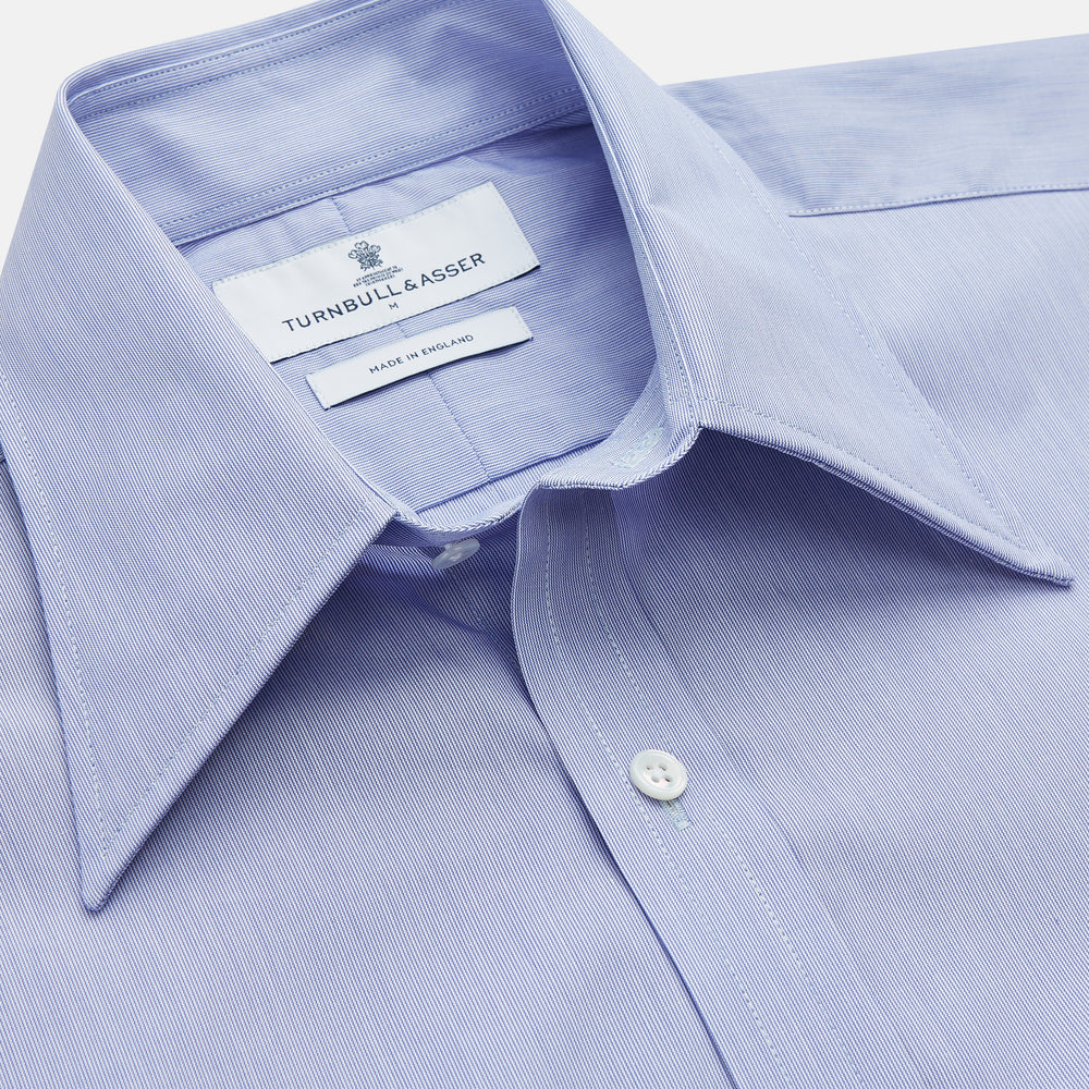 The Turnbull & Asser Pale Blue Weekend Fit Shirt with a Long Point collar and single button cuffs is laid flat on a white background.
