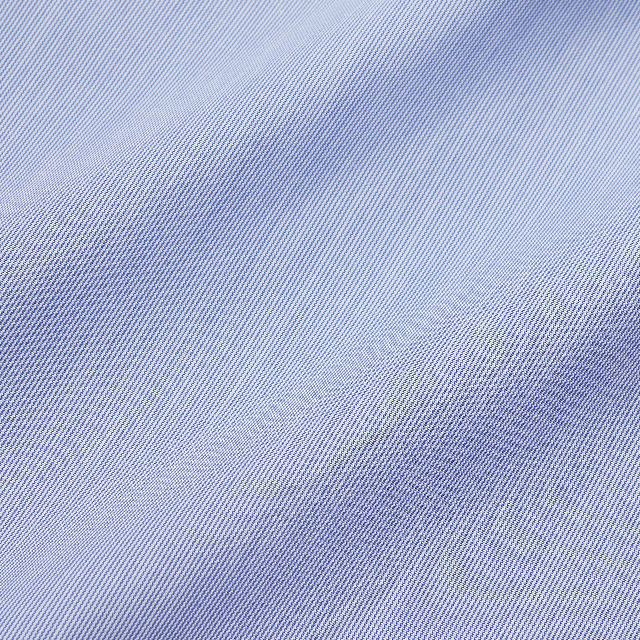 View 4 of product The Turnbull & Asser Pale Blue Weekend Fit Shirt with a Long Point collar and single button cuffs is laid flat on a white background.