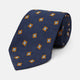 The Turnbull & Asser Orange Multi Geo Silk Tie, featuring a vibrant geometric pattern, is showcased rolled up on a plain white background—an elegant piece from our autumn-winter collection.
