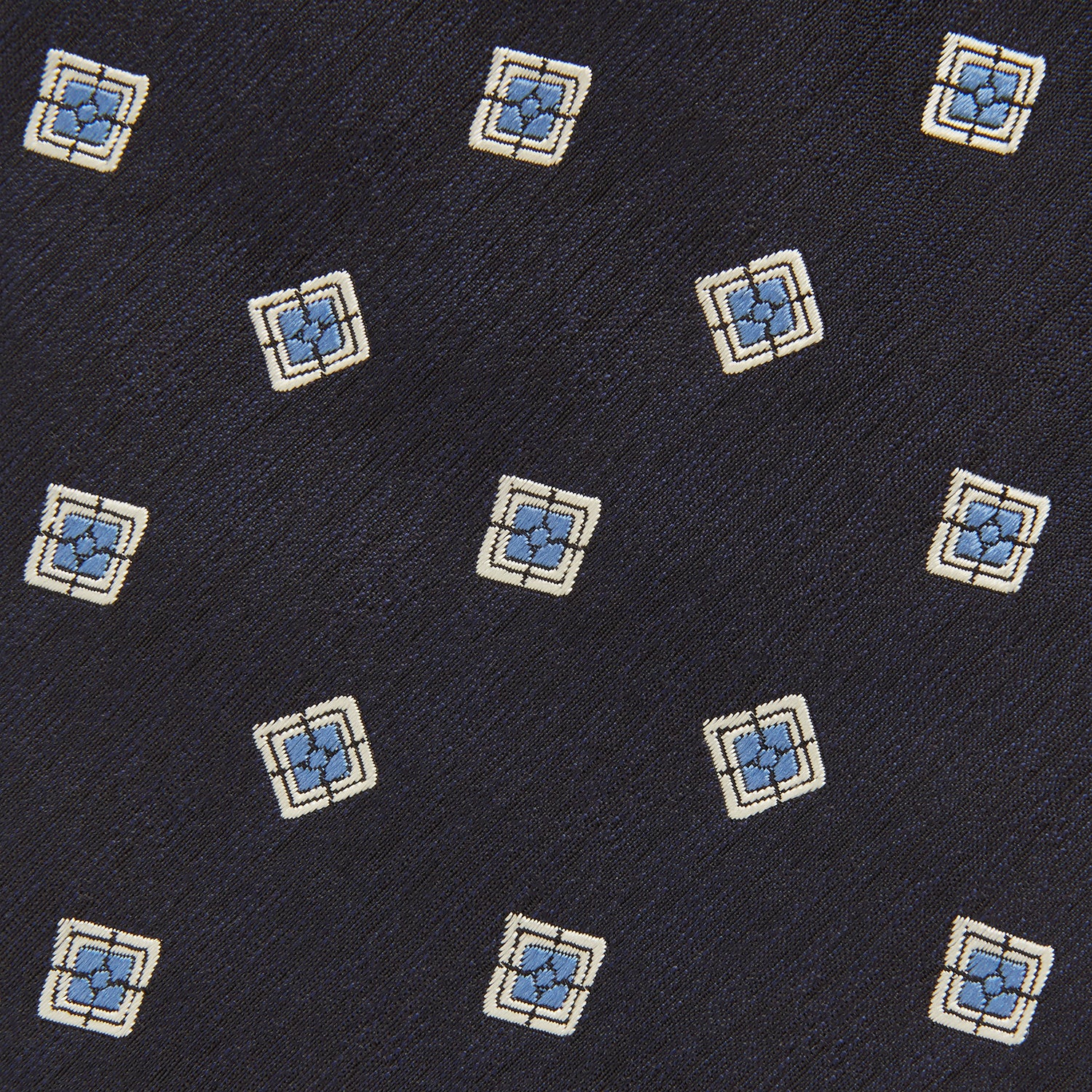 View 3 of product The Turnbull & Asser Navy Multi Geo Silk Tie features a dark navy blue geometric pattern with blue and cream squares—ideal for pairing with bold signature shirts from the autumn-winter collection.