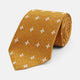 The Orange Multi Neat Silk Tie by Turnbull & Asser, from the autumn-winter collection, features a golden yellow geometric pattern on textured silk. Shown rolled on a white background, it pairs perfectly with bold signature shirts.
