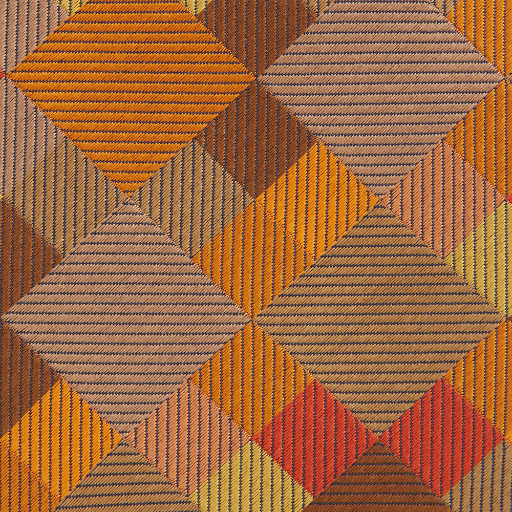 A close up of the Turnbull & Asser Orange Multi Pixel Silk Tie, featuring a refined checked design—ideal for elevating your autumn-winter style.