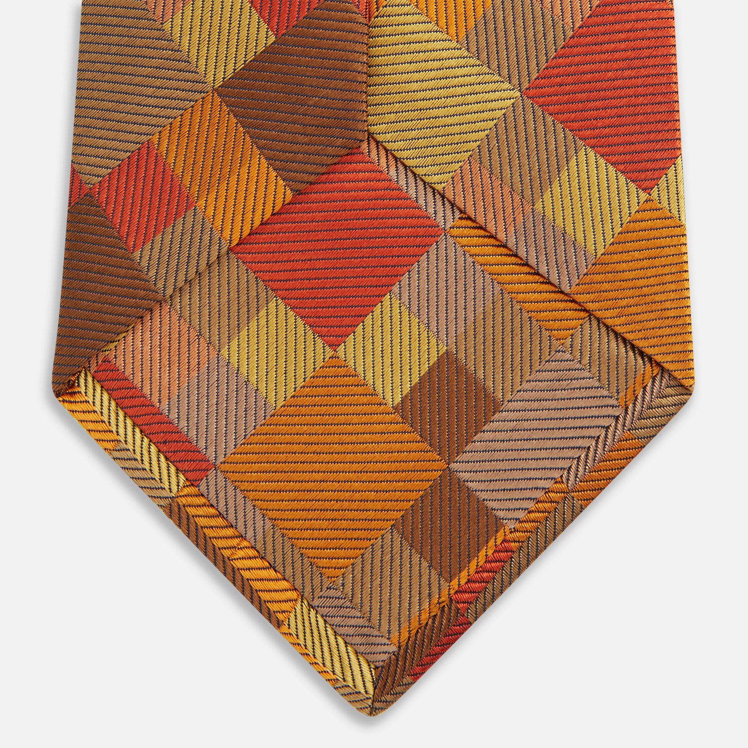 View 4 of product A close up of the Turnbull & Asser Orange Multi Pixel Silk Tie, featuring a refined checked design—ideal for elevating your autumn-winter style.