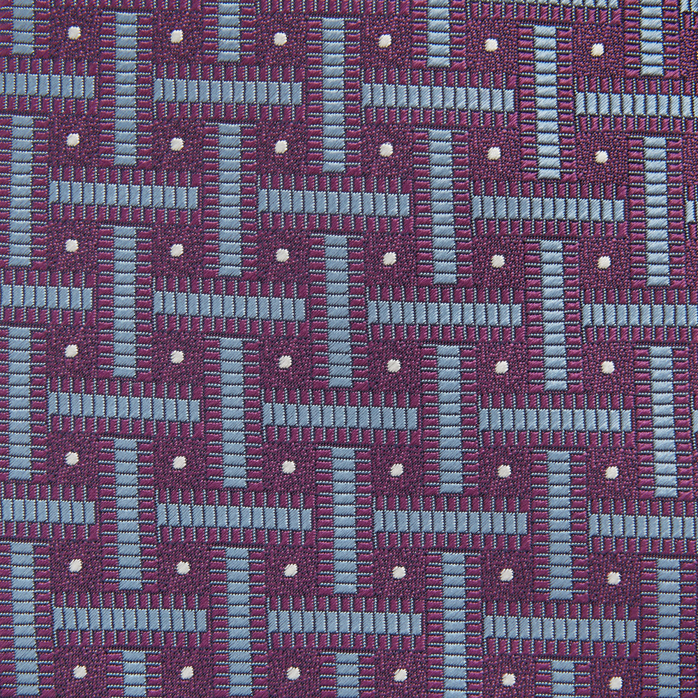 The Turnbull & Asser Purple & Navy Cross Silk Tie features a geometric pattern of intersecting blue lines and white dots—an ideal accessory to elevate formal outfits or complement signature shirts.