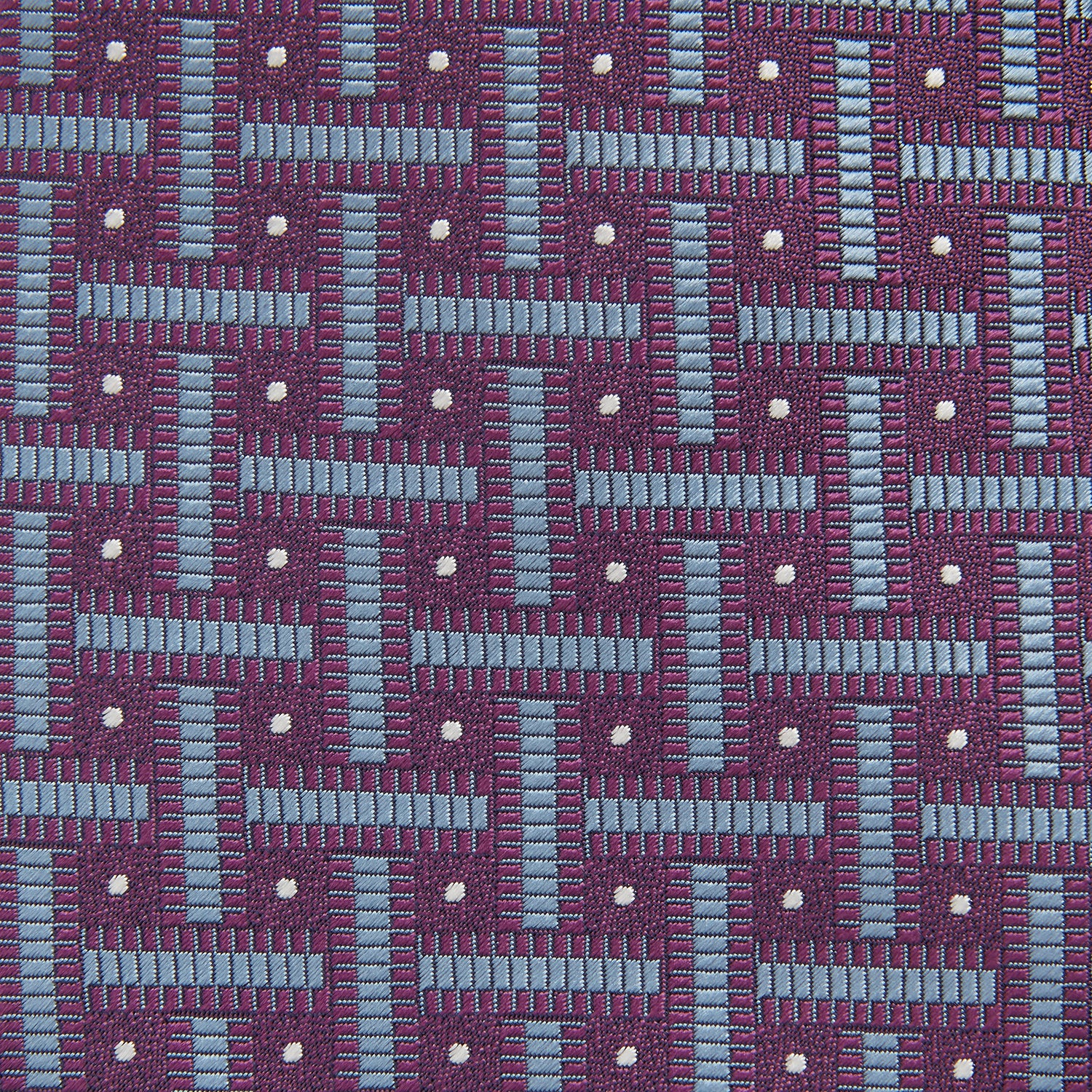 View 3 of product The Turnbull & Asser Purple & Navy Cross Silk Tie features a geometric pattern of intersecting blue lines and white dots—an ideal accessory to elevate formal outfits or complement signature shirts.