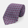 View 1 of product The Turnbull & Asser Purple & Navy Cross Silk Tie features a geometric pattern of intersecting blue lines and white dots—an ideal accessory to elevate formal outfits or complement signature shirts.