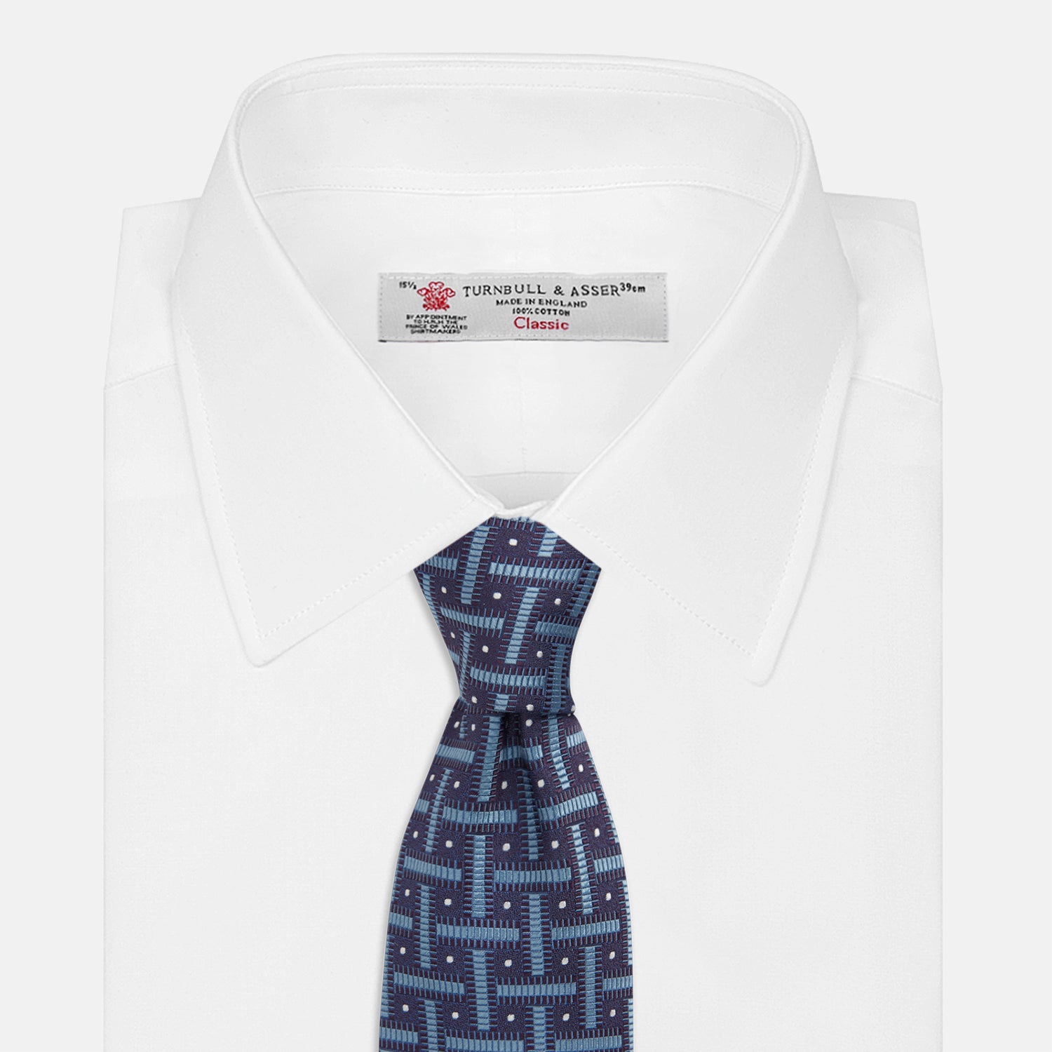 View 2 of product The Turnbull & Asser Navy & Blue Cross Silk Tie features a navy silk base with light blue and white geometric patterns and small white dots—ideal for elevating formal looks or pairing with signature shirts.