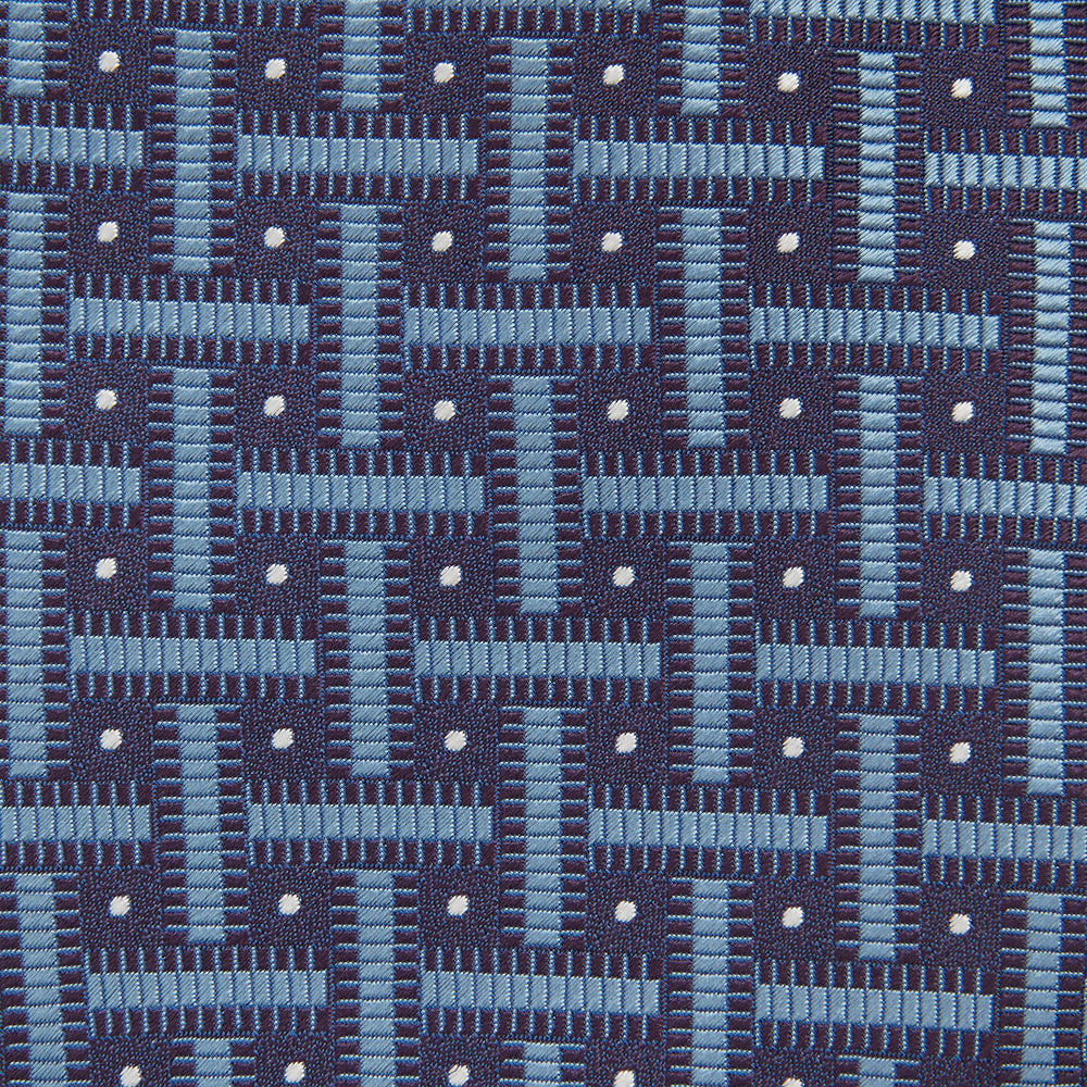 The Turnbull & Asser Navy & Blue Cross Silk Tie features a navy silk base with light blue and white geometric patterns and small white dots—ideal for elevating formal looks or pairing with signature shirts.