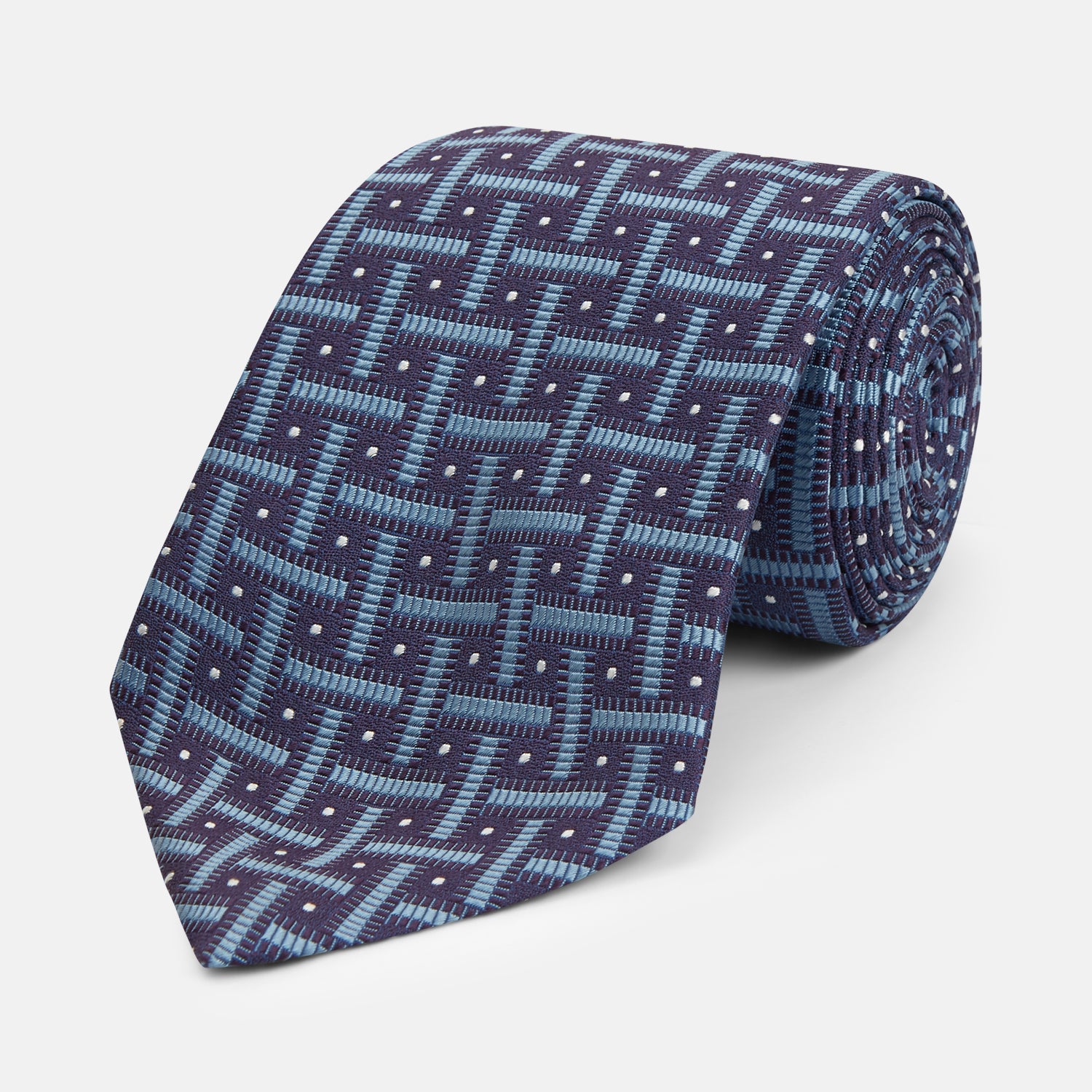 View 1 of product The Turnbull & Asser Navy & Blue Cross Silk Tie features a navy silk base with light blue and white geometric patterns and small white dots—ideal for elevating formal looks or pairing with signature shirts.