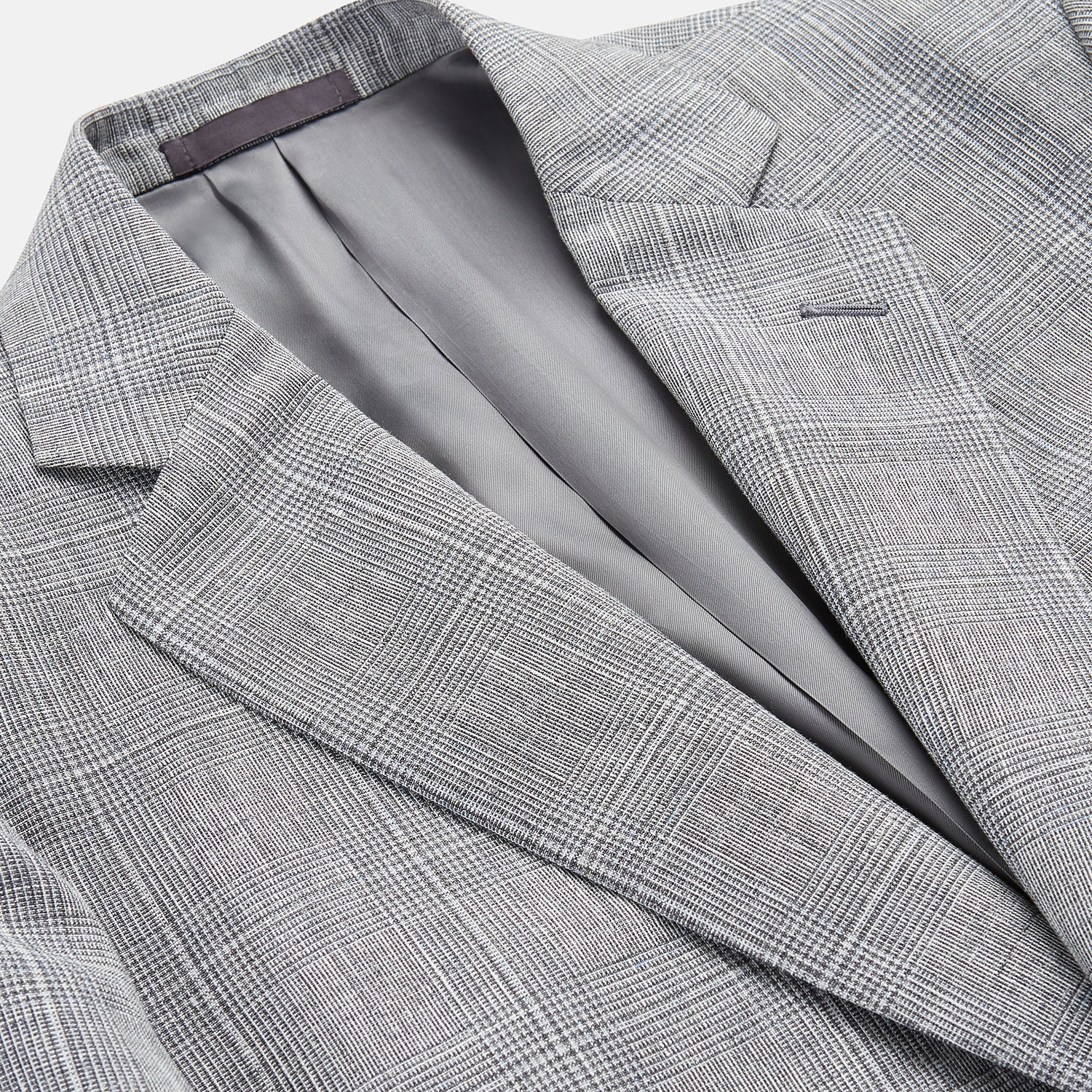 View 2 of product The Turnbull & Asser Grey Multi Check Linen Blend Barrington Blazer features notched lapels, a two-button single-breasted front, flap pockets, and buttoned cuffs, shown against a plain white background.