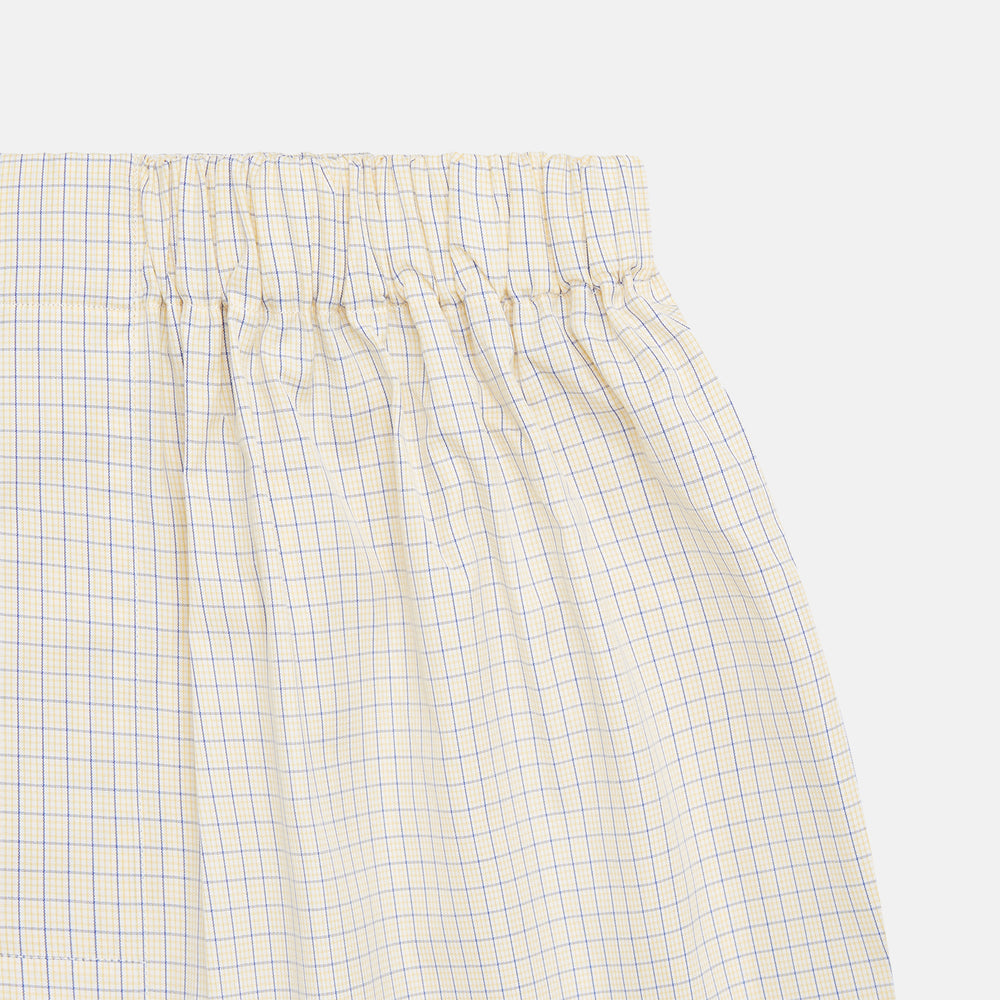 Turnbull & Asser’s Yellow and Blue Check Cotton RE-PURPOSE Godfrey Boxers are crafted from recycled fabric, featuring a yellow and blue check pattern, an elastic waistband, and shown on a plain white background.