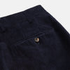 View 3 of product A pair of Turnbull & Asser Navy Horizontal Cord Nolan Trousers featuring a straight-leg fit, button and zip closure, front pleats, and classic horizontal cord texture, laid flat on a white background.