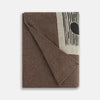 View 6 of product The Grey Wool And Cashmere Lily Blanket by Turnbull & Asser features an abstract animal outline in brown, beige, and dark grey on white. Expertly hand-finished, this folded blanket blends wool and cashmere for a luxurious touch.