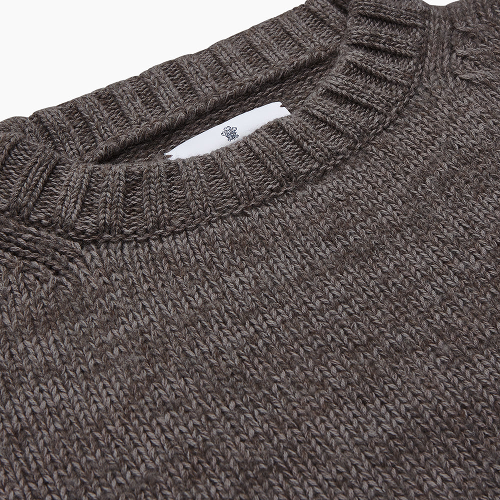 The Turnbull & Asser Fallow Wool and Cotton Blend Lewis Guernsey Jumper is a plain, long-sleeved dark gray knit with ribbed crew neck, cuffs, and hem, shown laid flat on a white background.