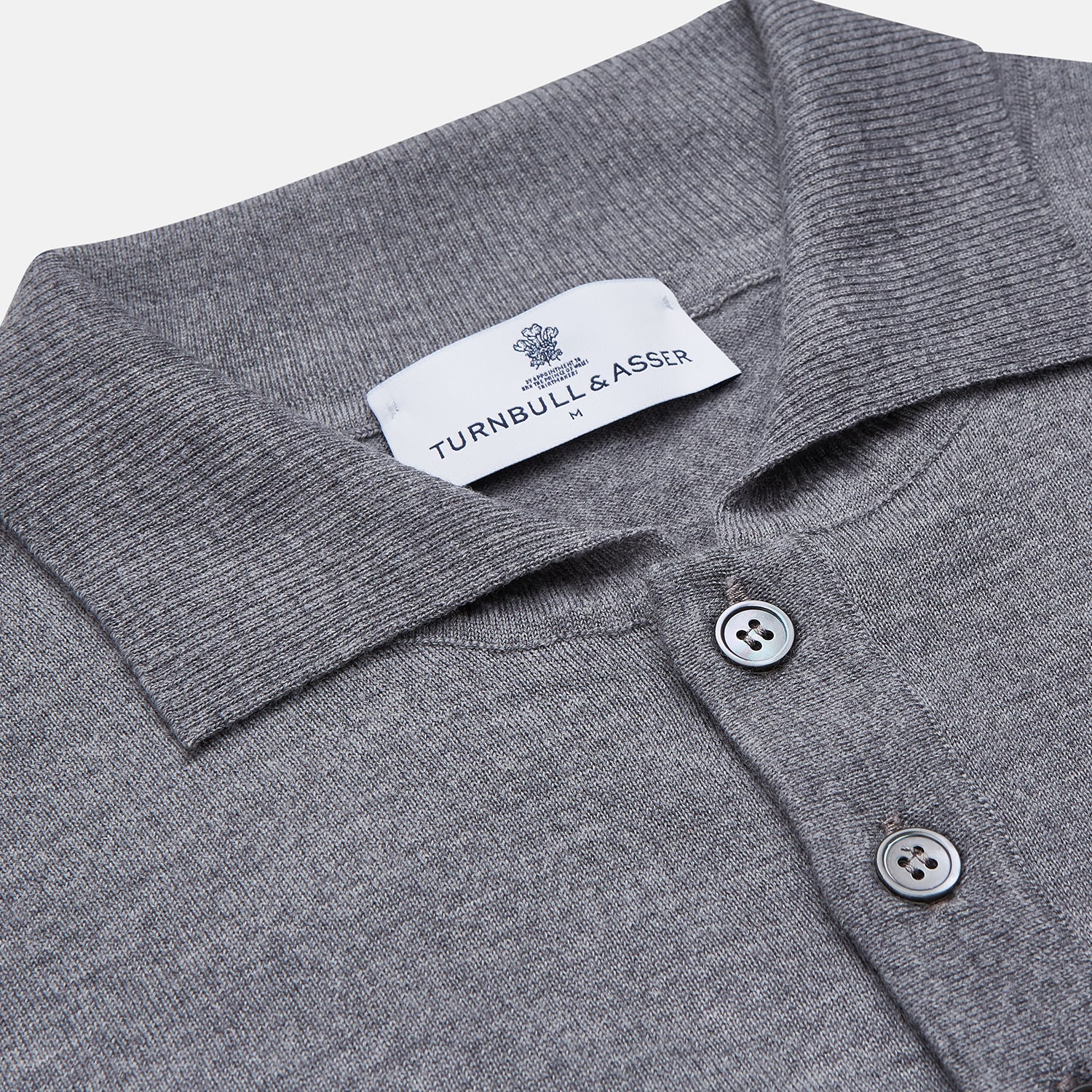 View 2 of product The Grey Merino Wool Cecil Rugby Polo Shirt by Turnbull & Asser features long sleeves, a collar, three-button placket, and ribbed hem and cuffs—an elevated menswear staple shown flat on a white background.