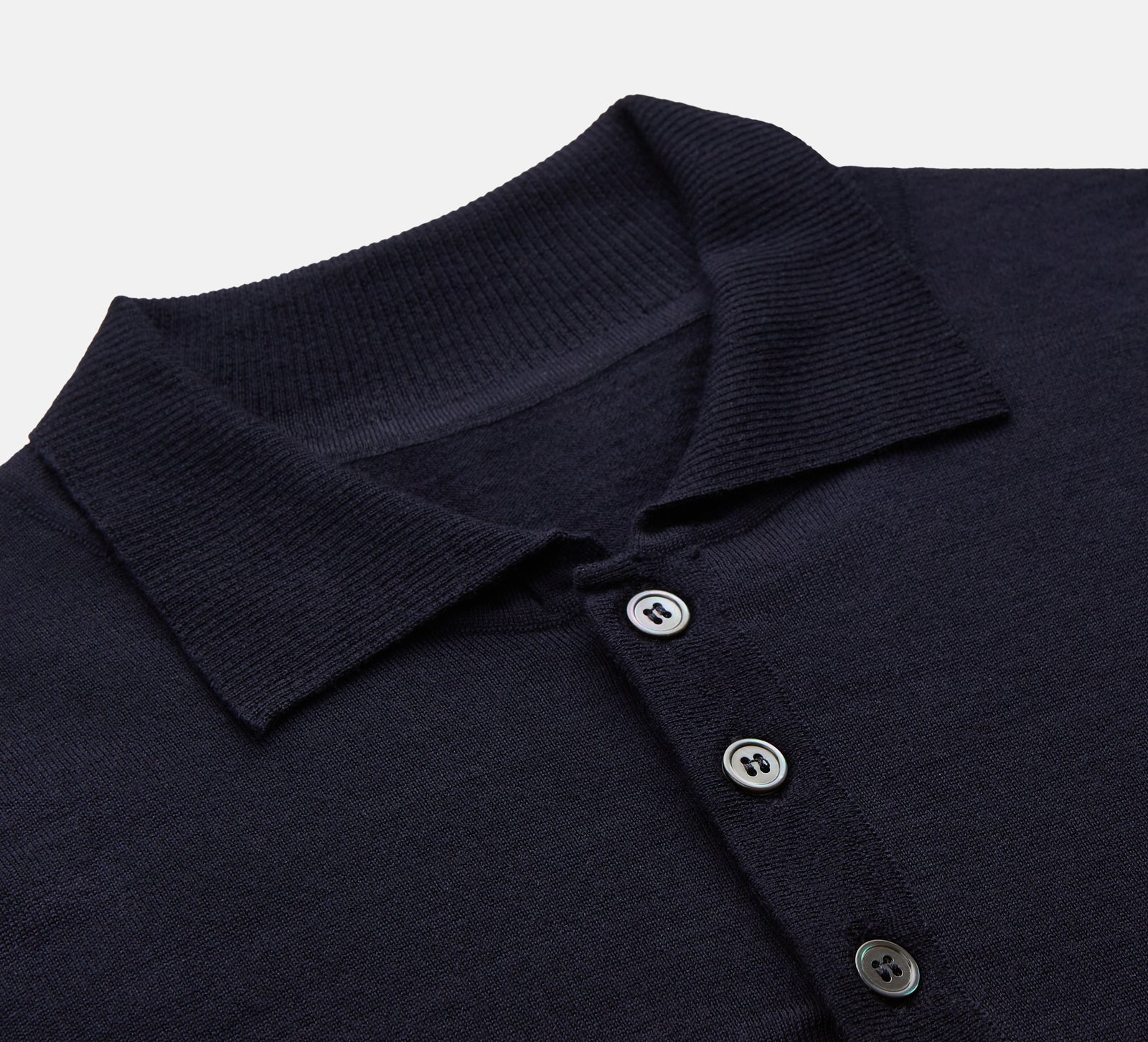 View 2 of product The Navy Merino Wool Cecil Rugby Polo Shirt by Turnbull & Asser features long sleeves, a collar, and a three-button placket—a timeless menswear staple laid flat on a white background.