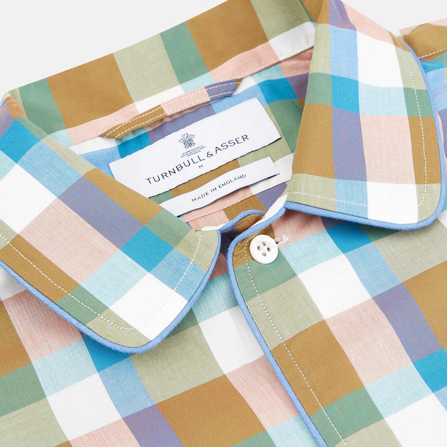 View 2 of product The Green and Pink Multi Check Linen Blend Sussex Nightshirt by Turnbull & Asser is a soft, long-sleeved sleepwear piece with a colorful plaid pattern, button-down front, chest pocket, and rounded hem—ideal as stylish luxury nightwear.