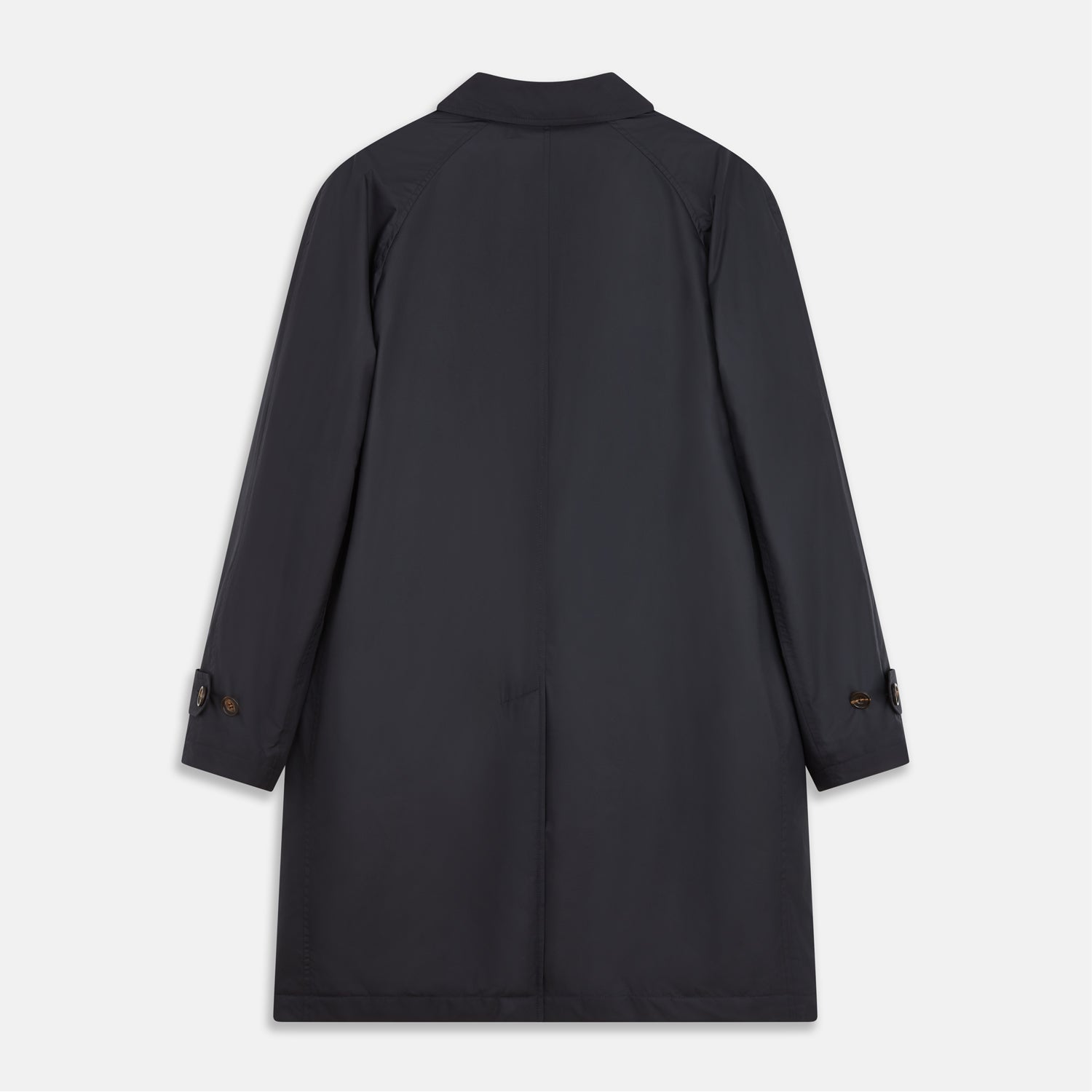 View 5 of product A man with brown hair stands outdoors, hands in his pockets, wearing a Turnbull & Asser Navy Sealup Quilted Liner Quintern Car Coat over a mustard cardigan. A glass barrier and blurred background are behind him.