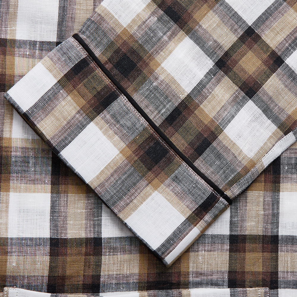 The Turnbull & Asser Brown Multi Check Linen Hyde Pyjama Set features a button-up, long-sleeve top and pants with a brown, black, and white plaid pattern, shown on a white background.
