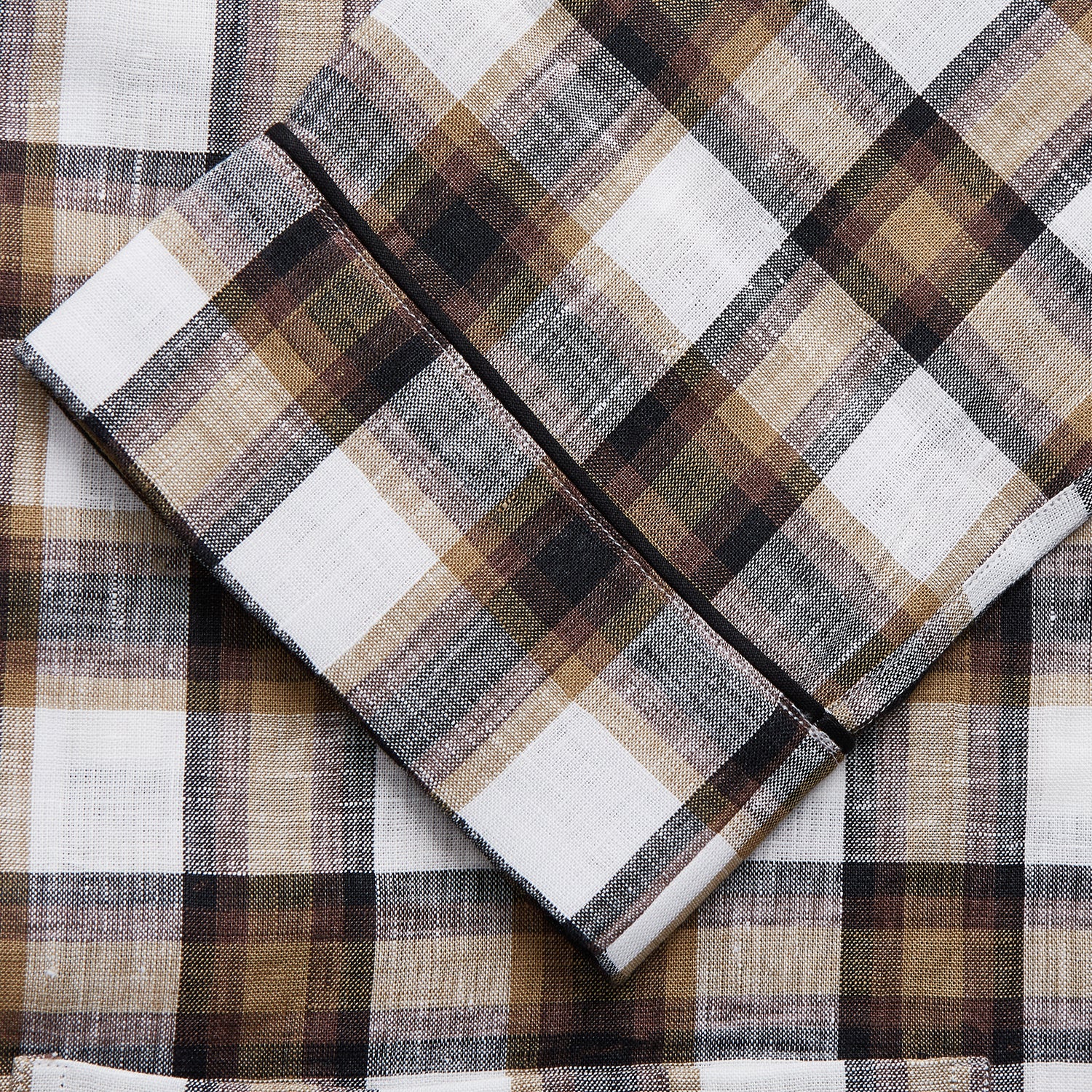 View 2 of product The Turnbull & Asser Brown Multi Check Linen Hyde Pyjama Set features a button-up, long-sleeve top and pants with a brown, black, and white plaid pattern, shown on a white background.