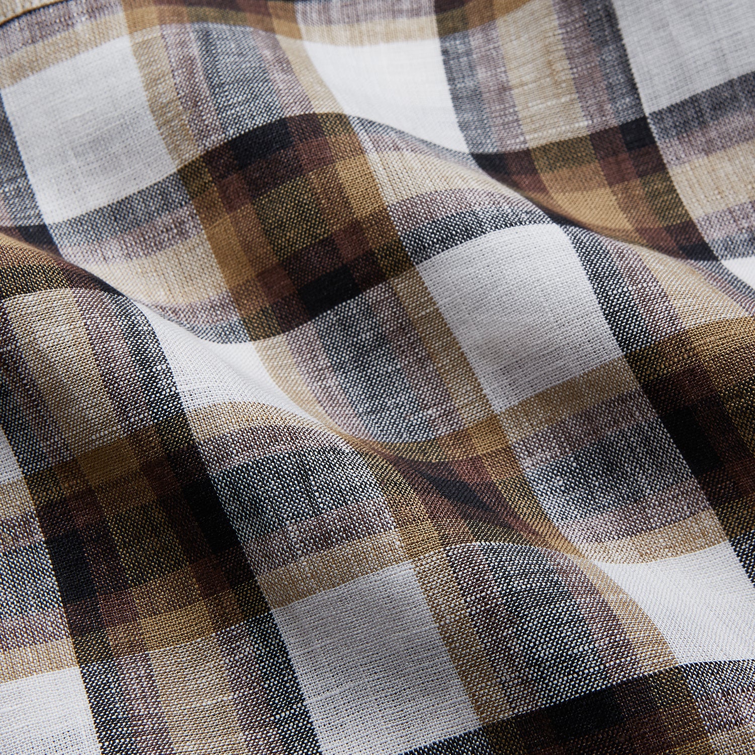 View 3 of product The Turnbull & Asser Brown Multi Check Linen Hyde Pyjama Set features a button-up, long-sleeve top and pants with a brown, black, and white plaid pattern, shown on a white background.